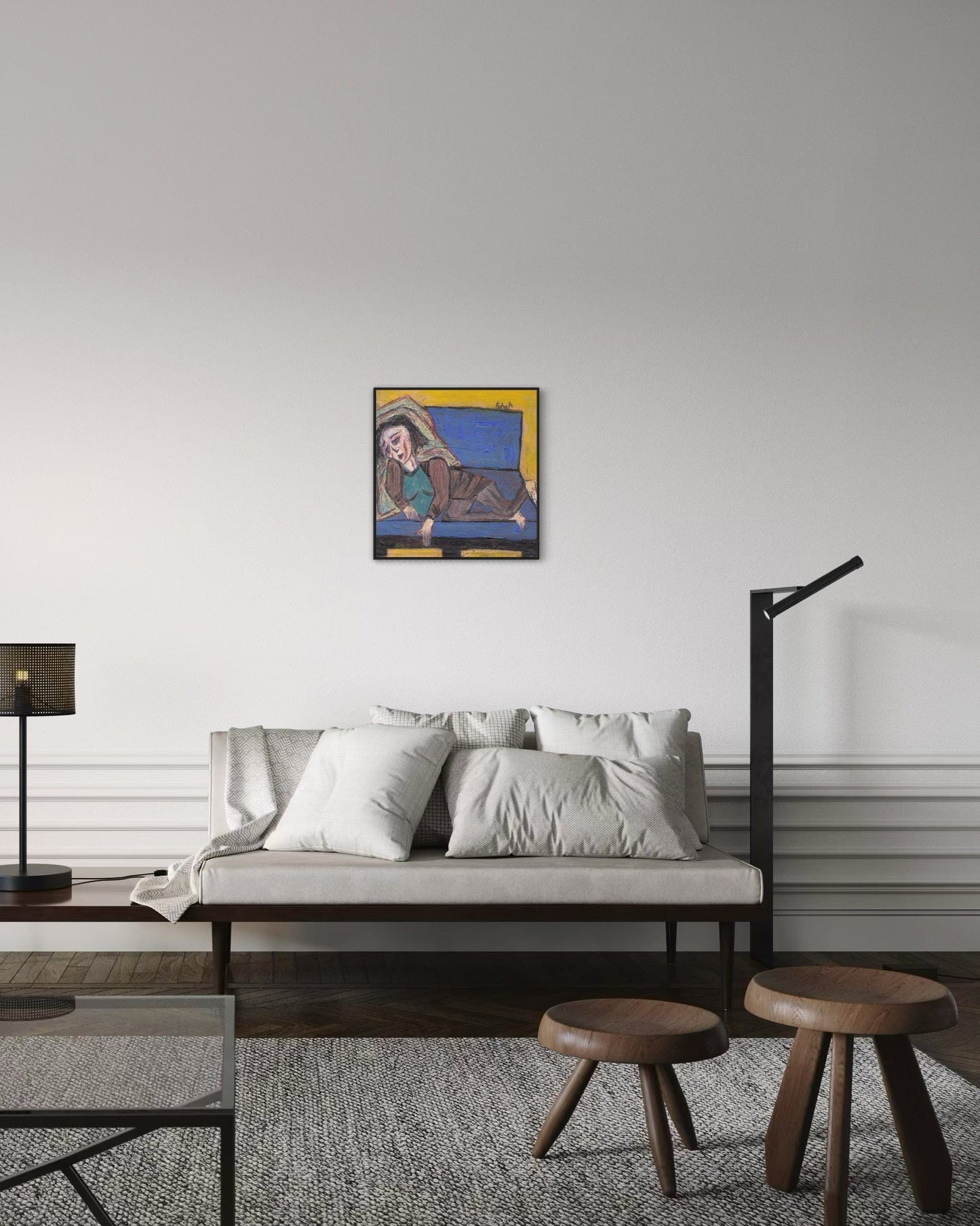 Modern living room with a sofa, coffee table, and wall art.