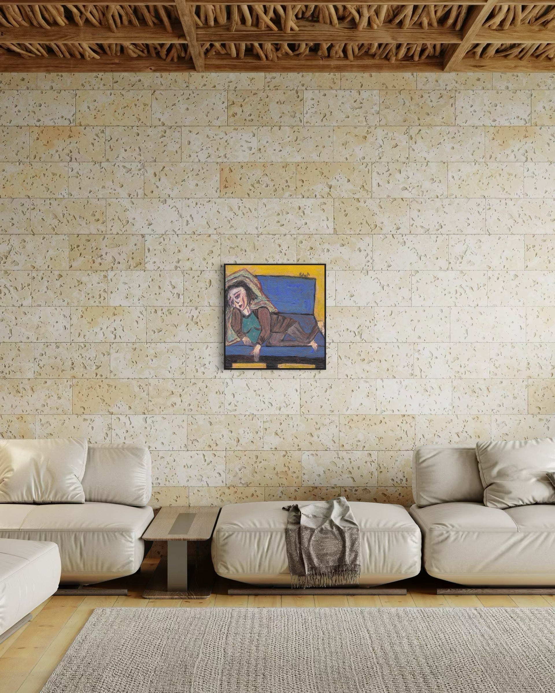 Living room with beige walls, a white sofa, and a framed painting.