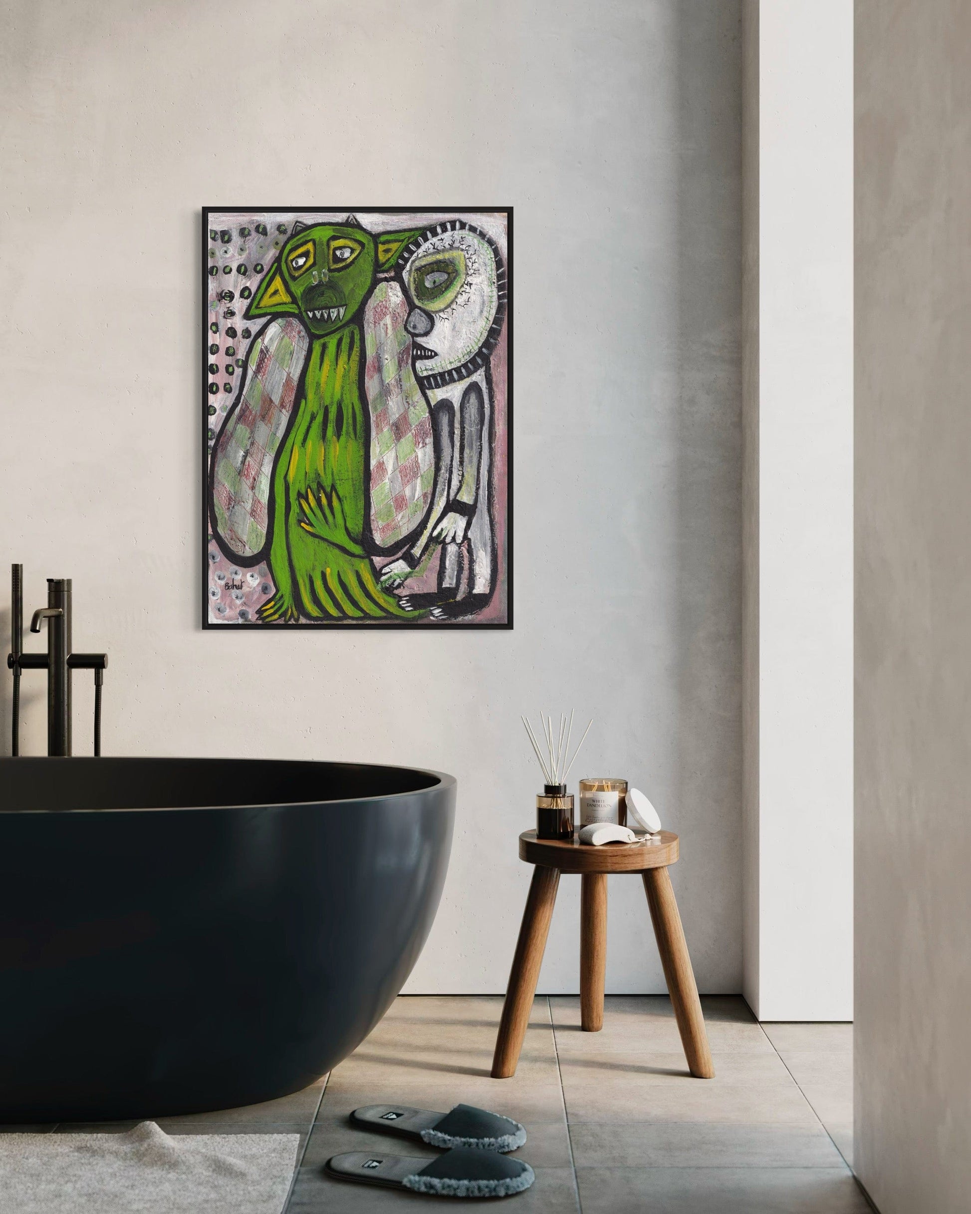 Modern bathroom with a black freestanding bathtub, wooden stool, and abstract art on the wall.