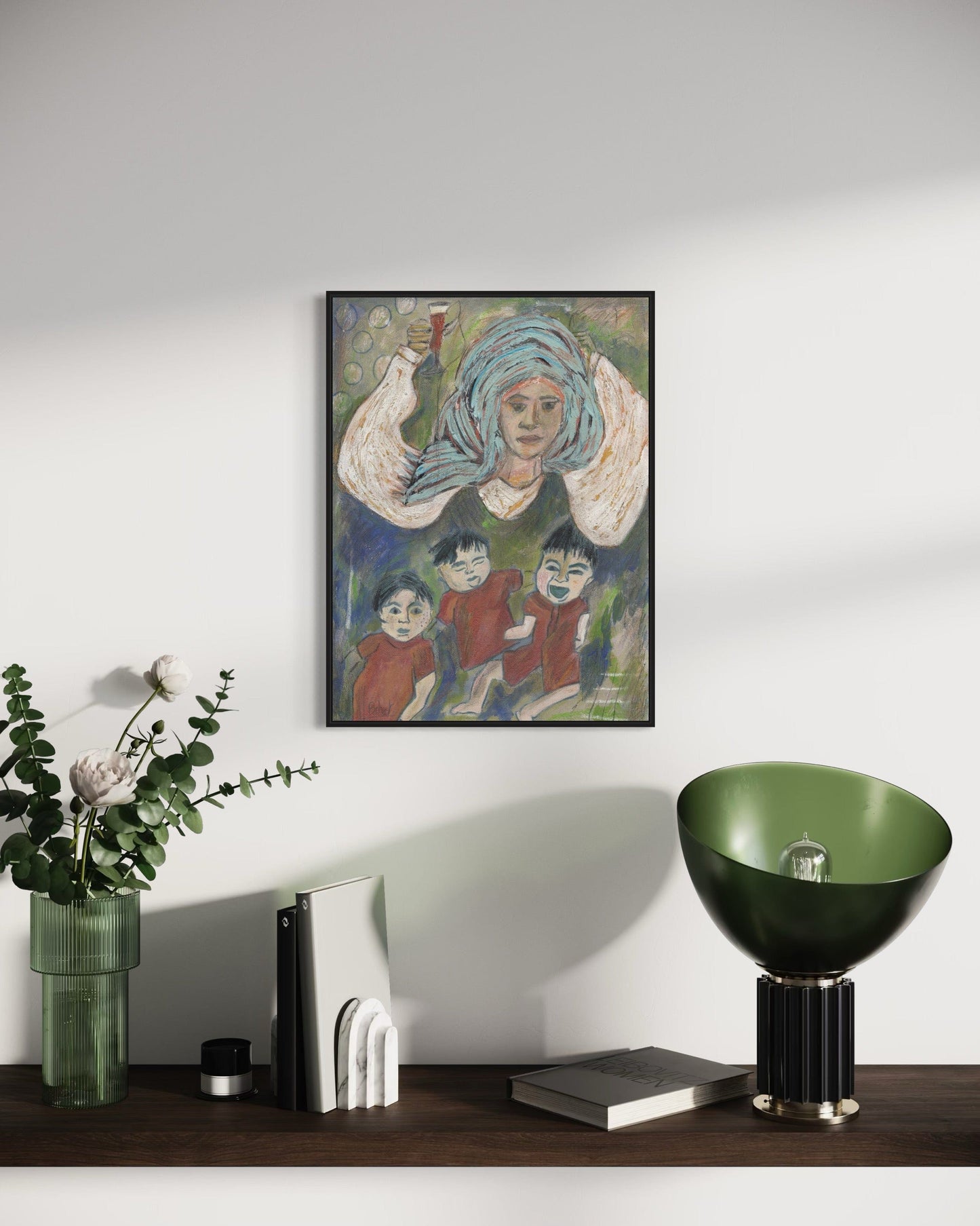 Framed artwork on a wall above a wooden surface with decorative items.