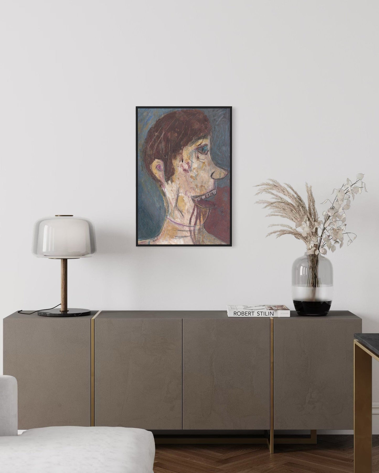 Living room with a sideboard, lamp, and framed artwork on the wall.