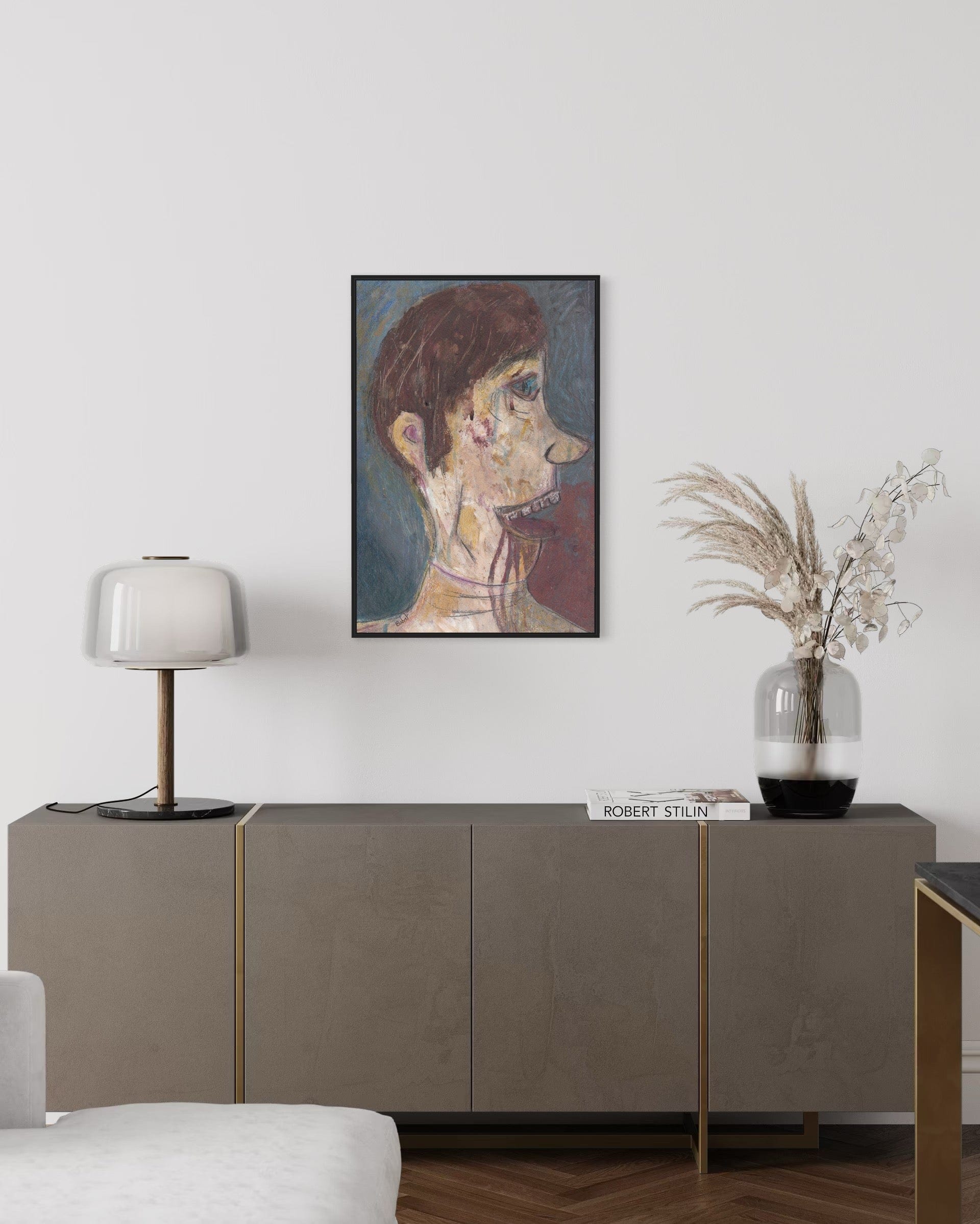 Living room with a sideboard, lamp, and framed artwork on the wall.