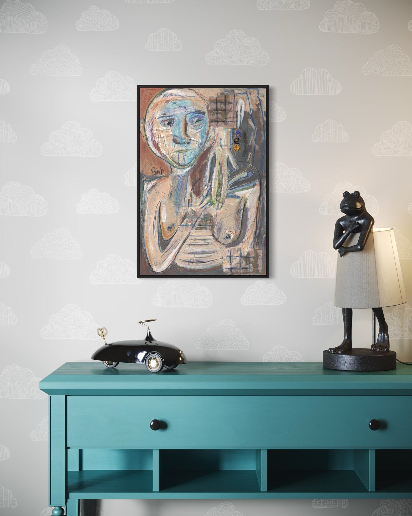 Teal console table with decorative items against a light gray wall with a subtle pattern.