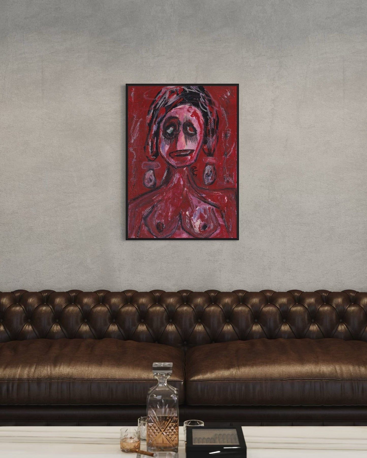 Framed artwork on a wall above a brown leather sofa