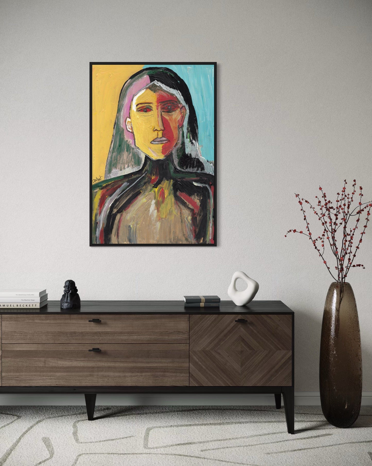 Abstract portrait painting on a wall above a wooden sideboard with decorative items.