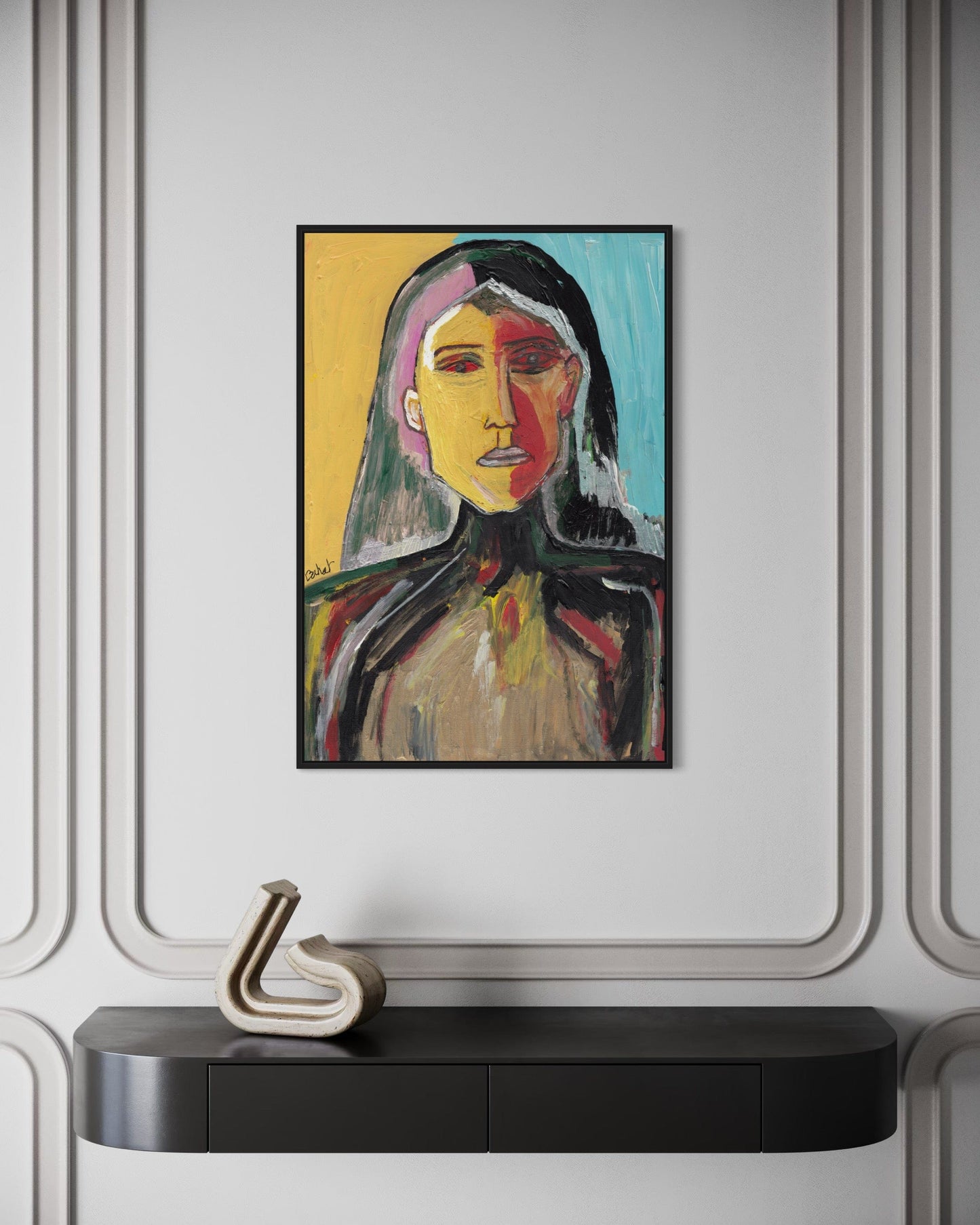 Framed abstract painting of a woman's portrait on a wall above a black console table.