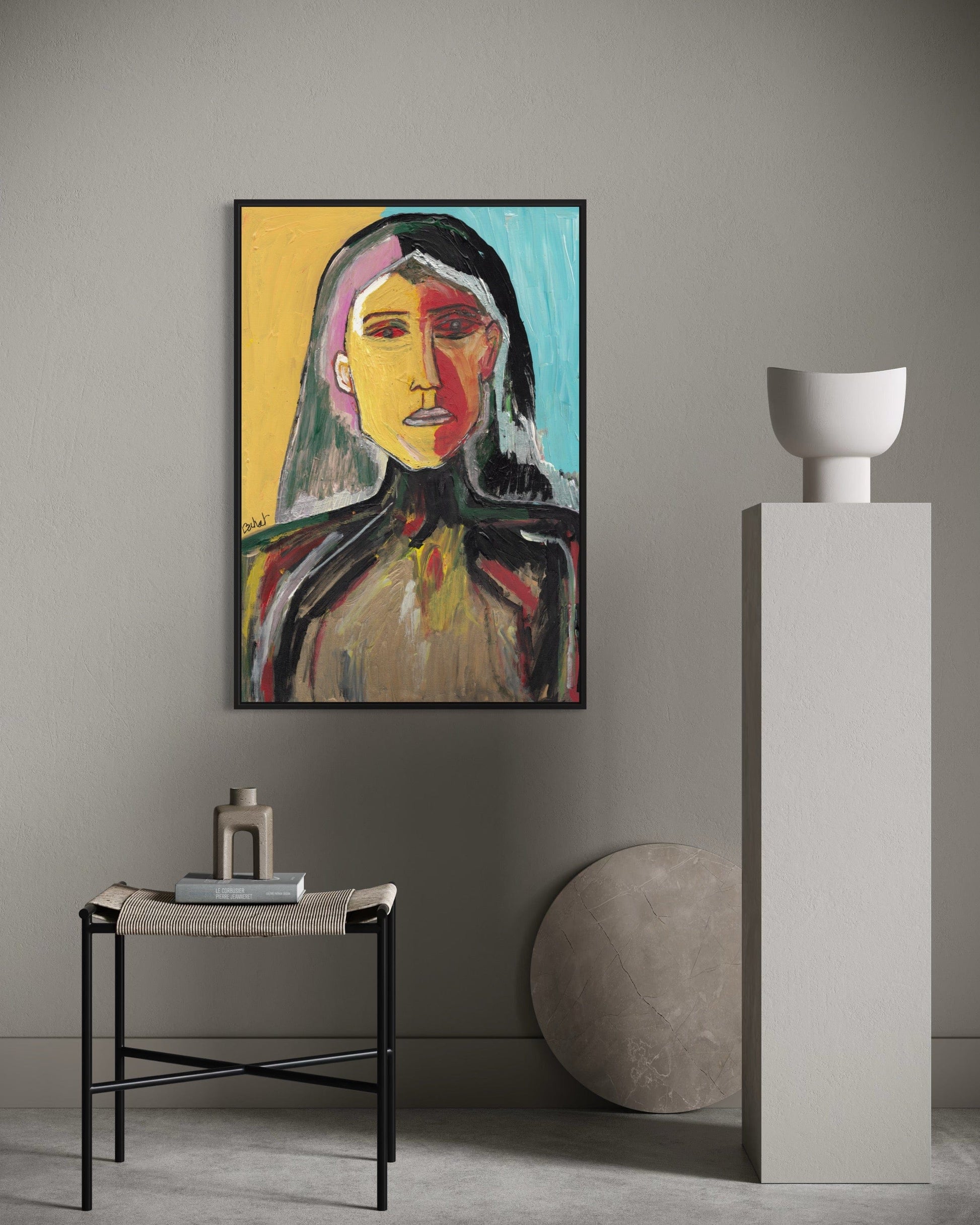 Abstract painting of a woman's face on a wall in a modern interior setting.