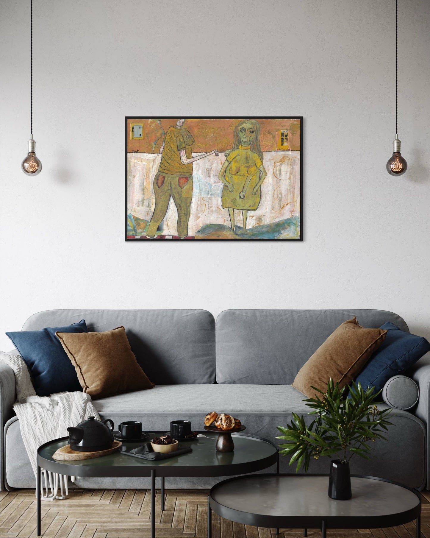Living room with a gray sofa, round coffee table, and abstract painting on the wall.
