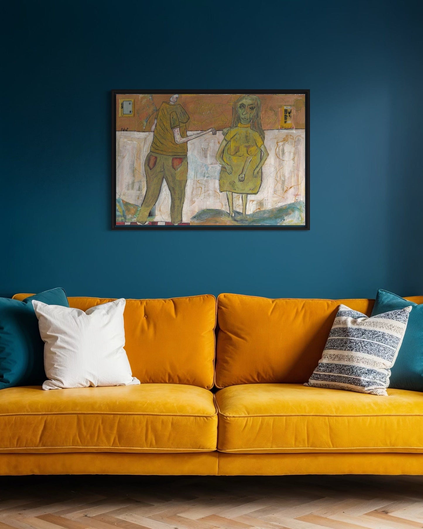 Yellow sofa with colorful cushions against a blue wall with a framed artwork.