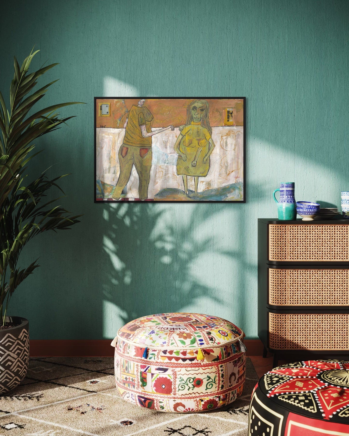 Decorative room with a painting on the wall, patterned ottomans, and a wicker cabinet.
