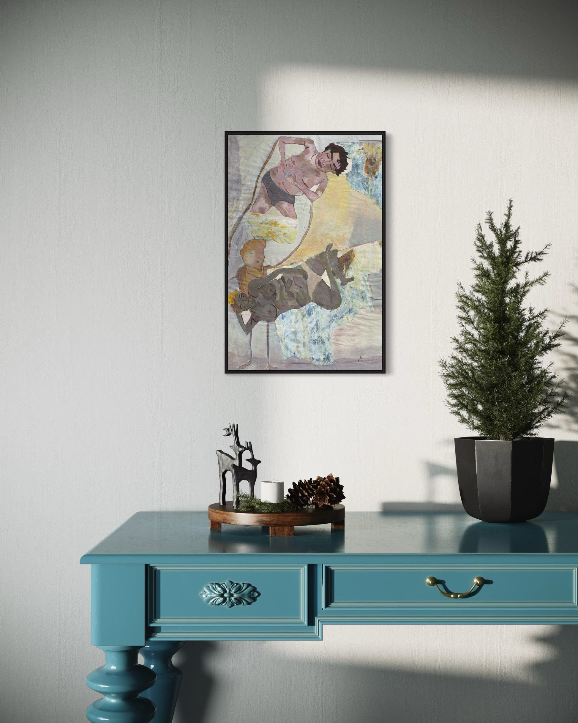 Teal desk with decorative items and a framed painting on a white wall.