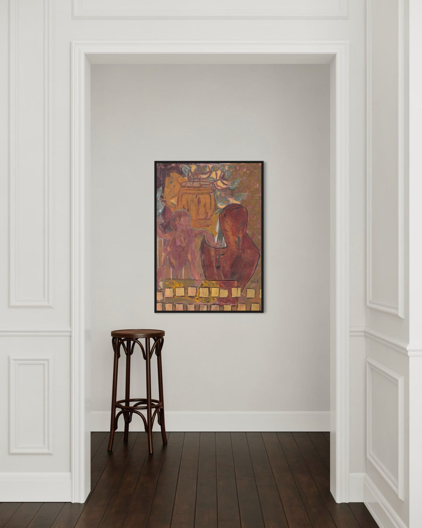 Framed artwork on a wall with a wooden stool in front