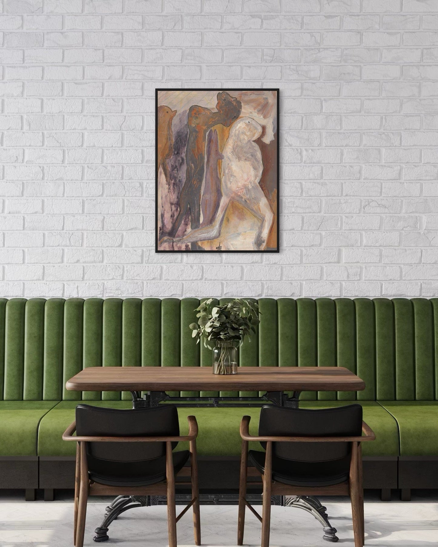 Green booth with wooden table and chairs against a white brick wall with a framed painting.