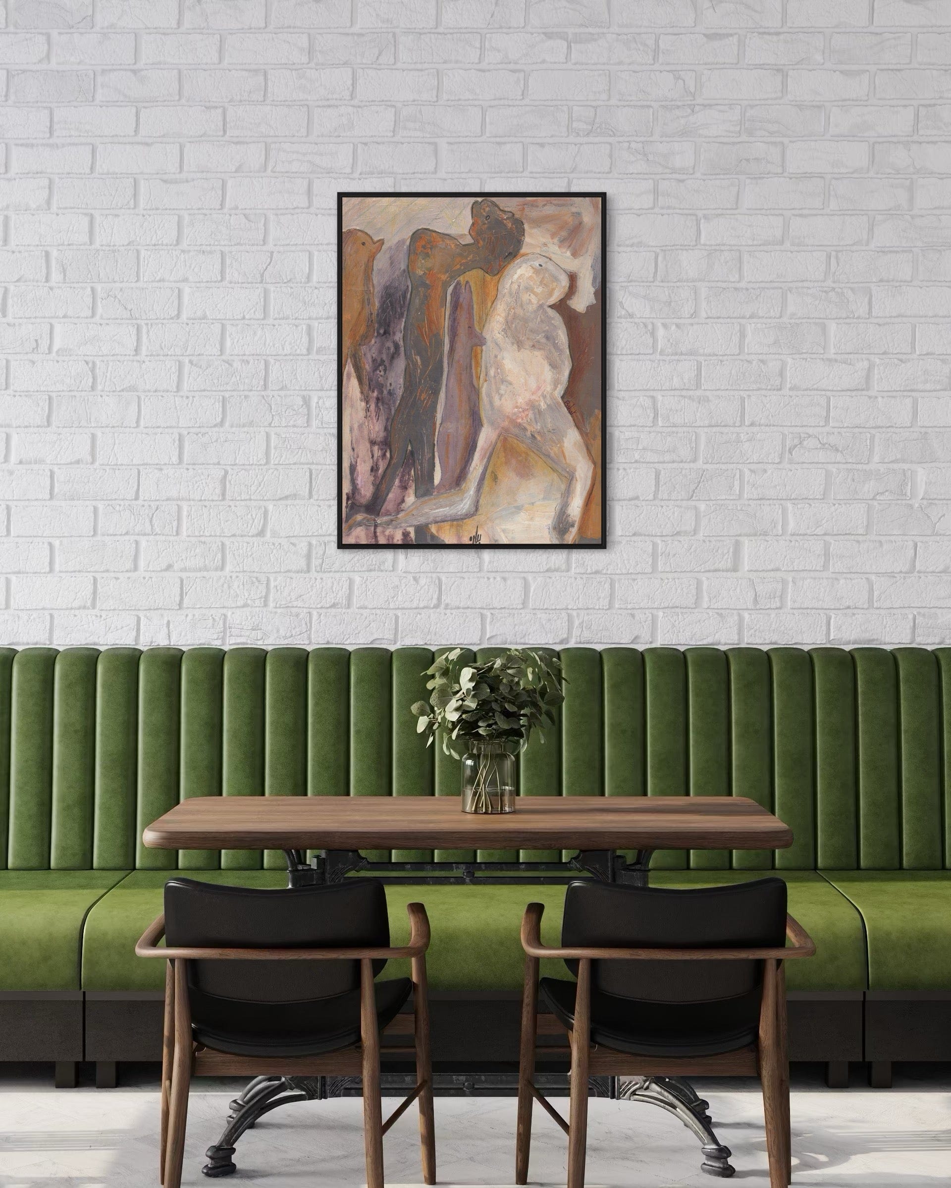 Green booth with wooden table and chairs against a white brick wall with a framed painting.