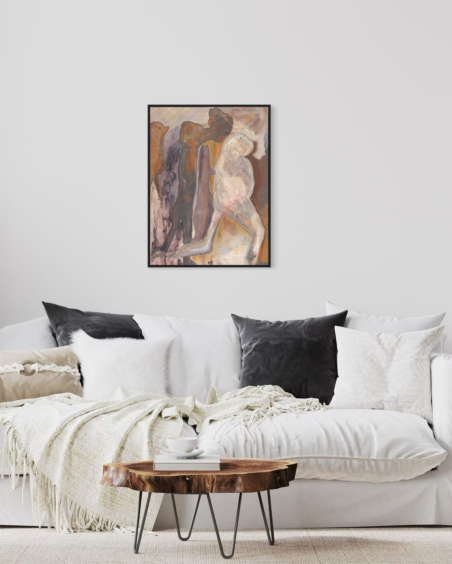Living room with a white sofa, abstract art on the wall, and a wooden coffee table.