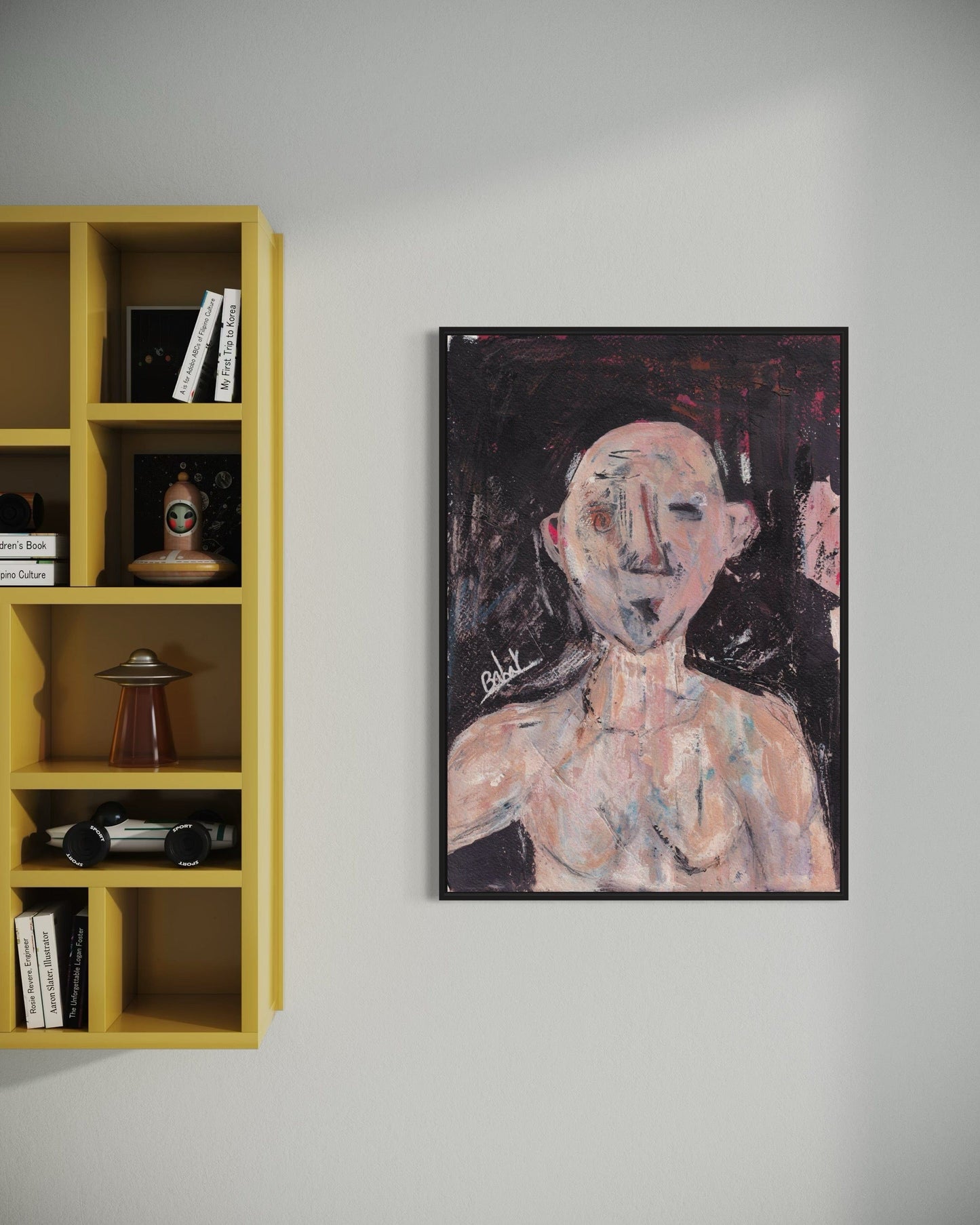 Framed abstract painting on a wall next to a yellow bookshelf.
