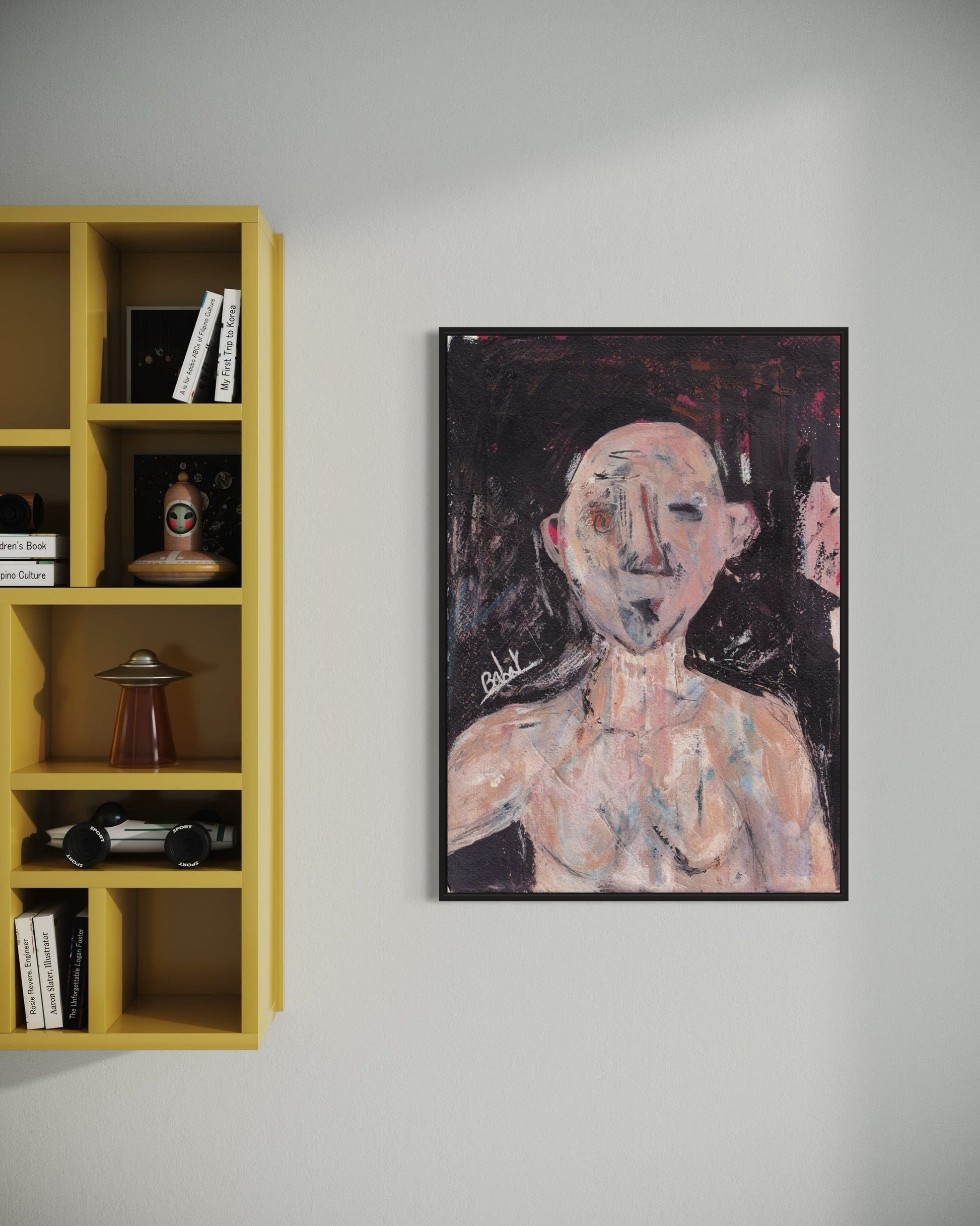 Framed abstract painting on a wall next to a yellow bookshelf.