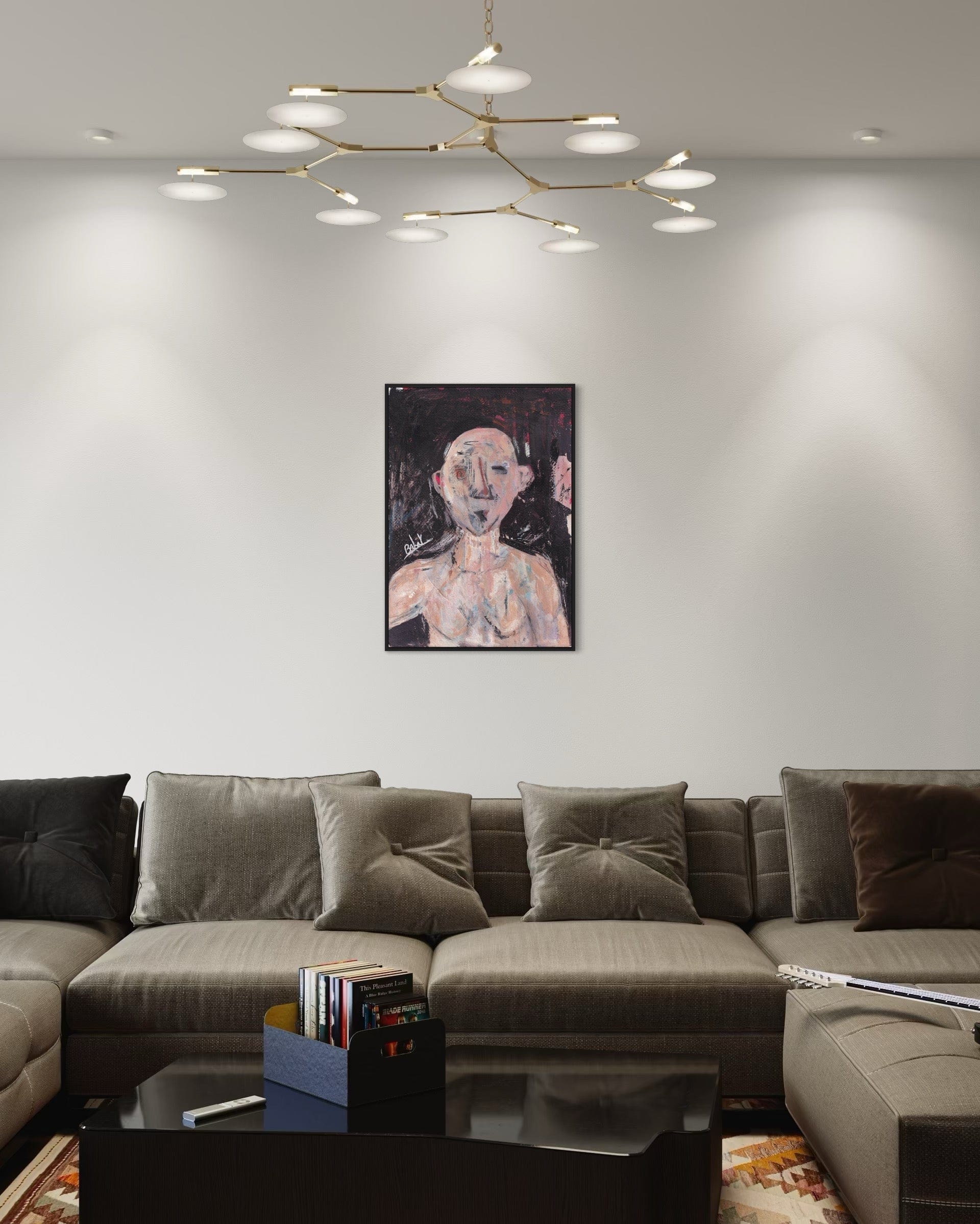 Modern living room with a gray sectional sofa, coffee table, and wall art.
