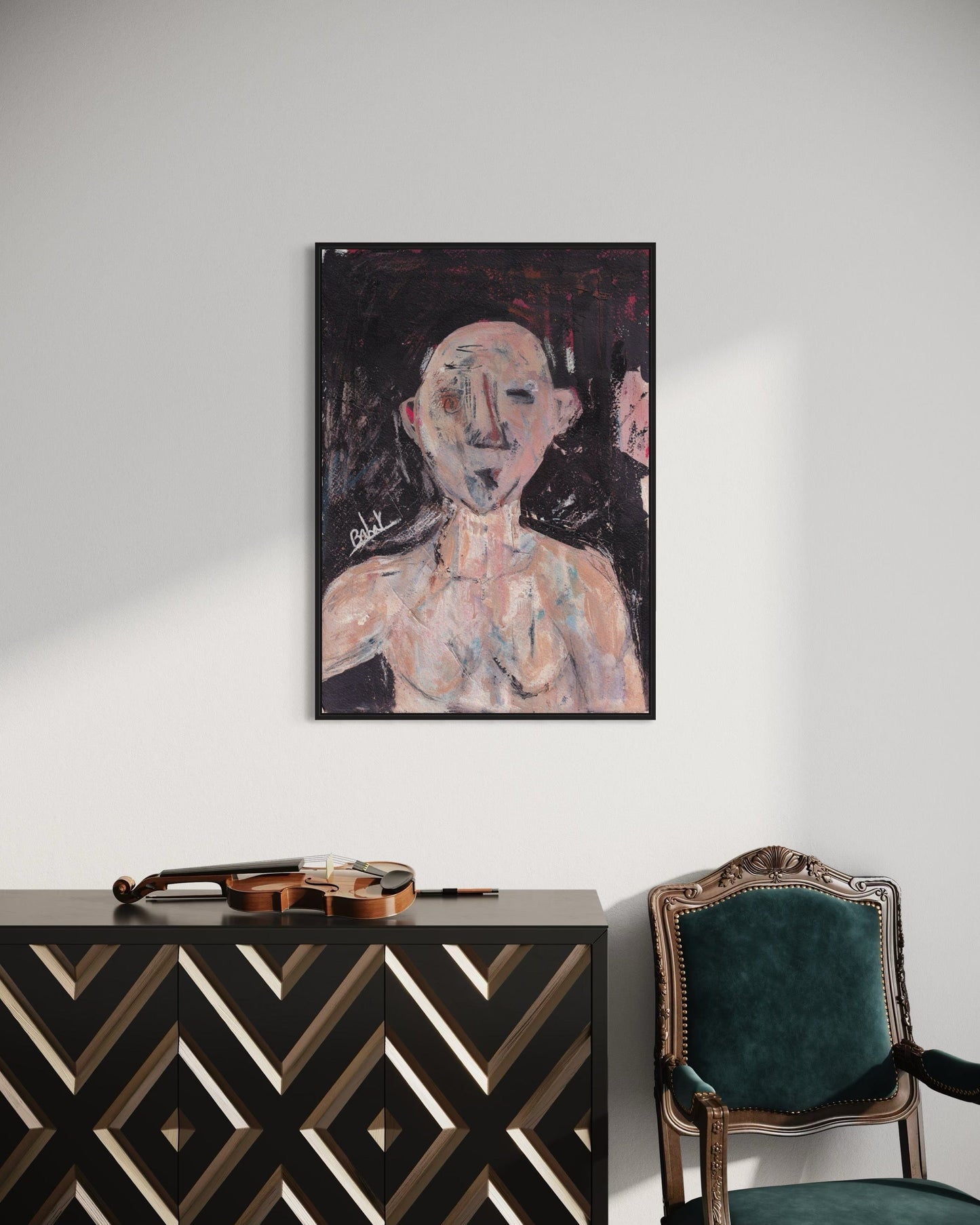 Abstract painting on a wall above a black and gold cabinet with a green chair.