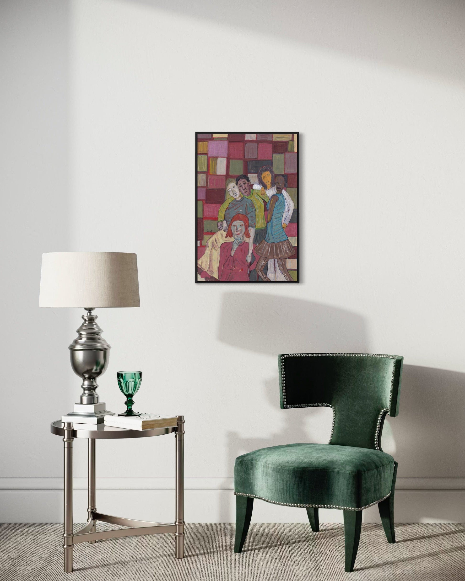 Green velvet chair in a room with a side table and lamp, and a colorful abstract painting on the wall.