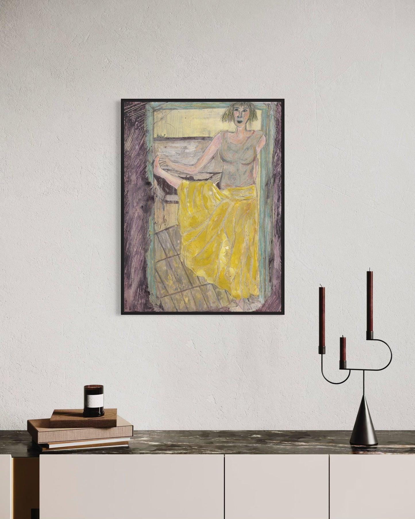 Framed artwork of a woman in a yellow dress on a wall above a console table.