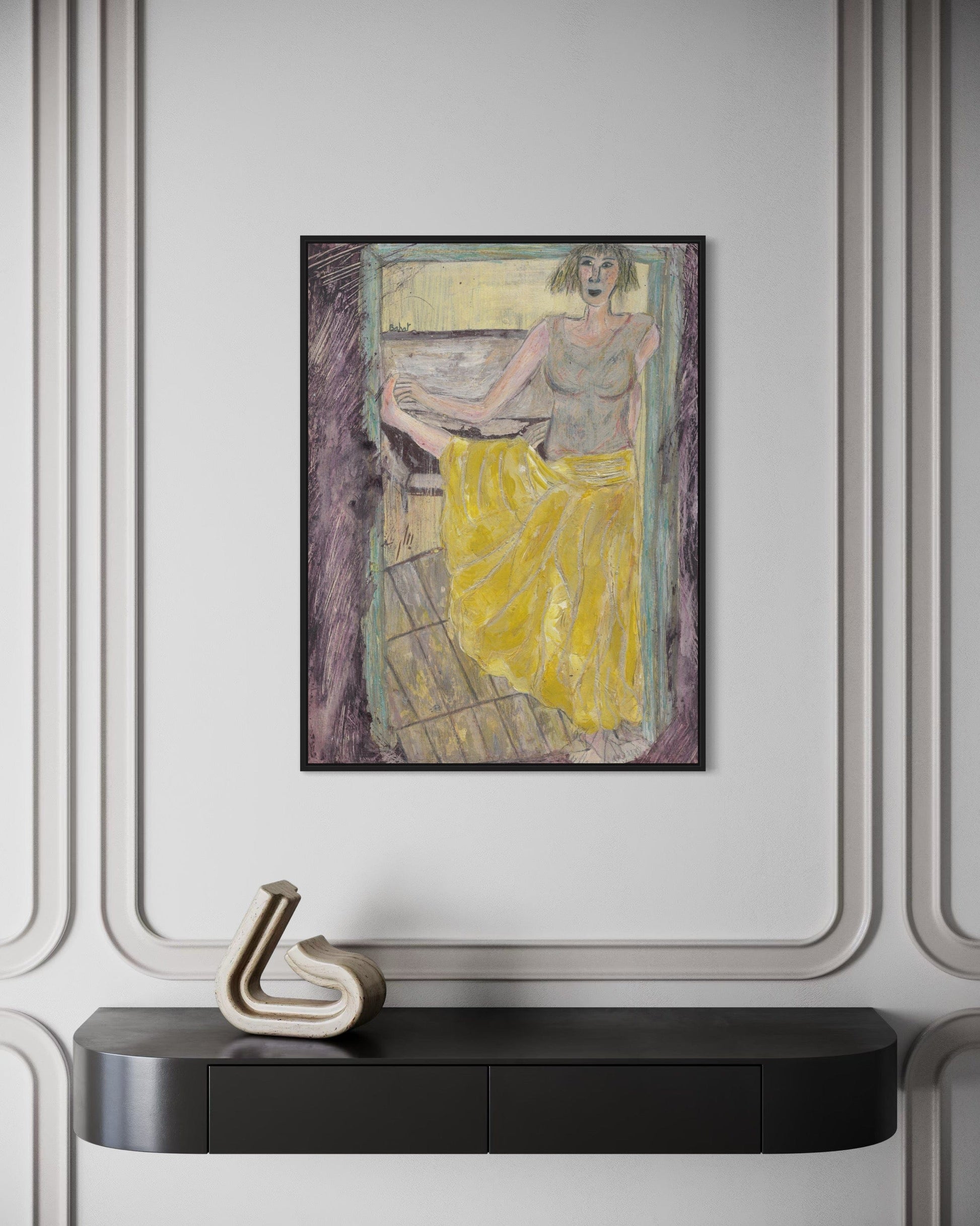 Framed artwork of a woman in a yellow dress on a wall above a black console table.
