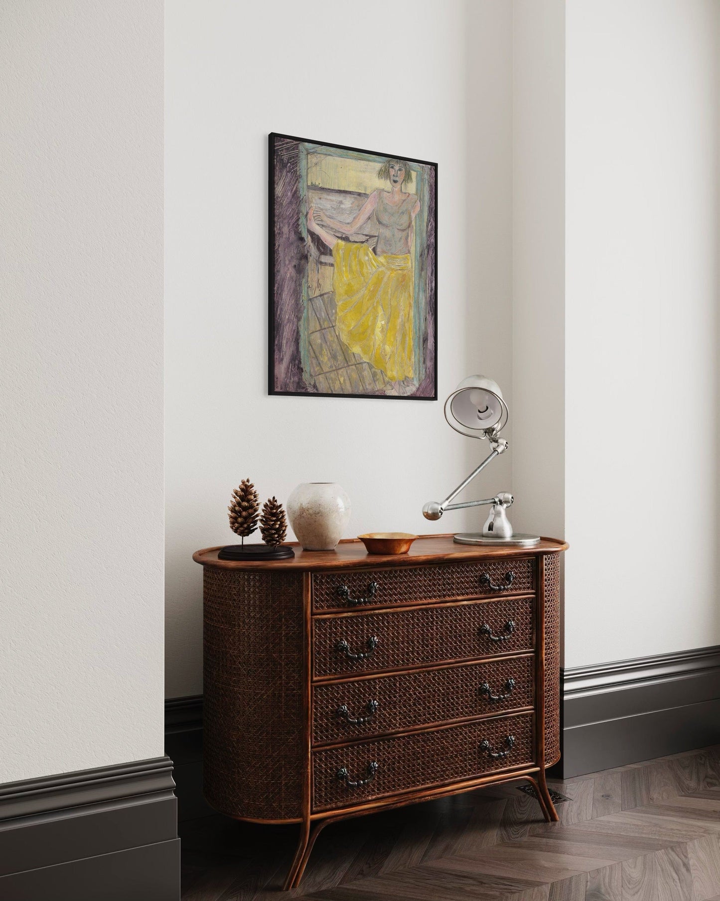 Wooden dresser with decorative items against a white wall with a framed abstract painting.