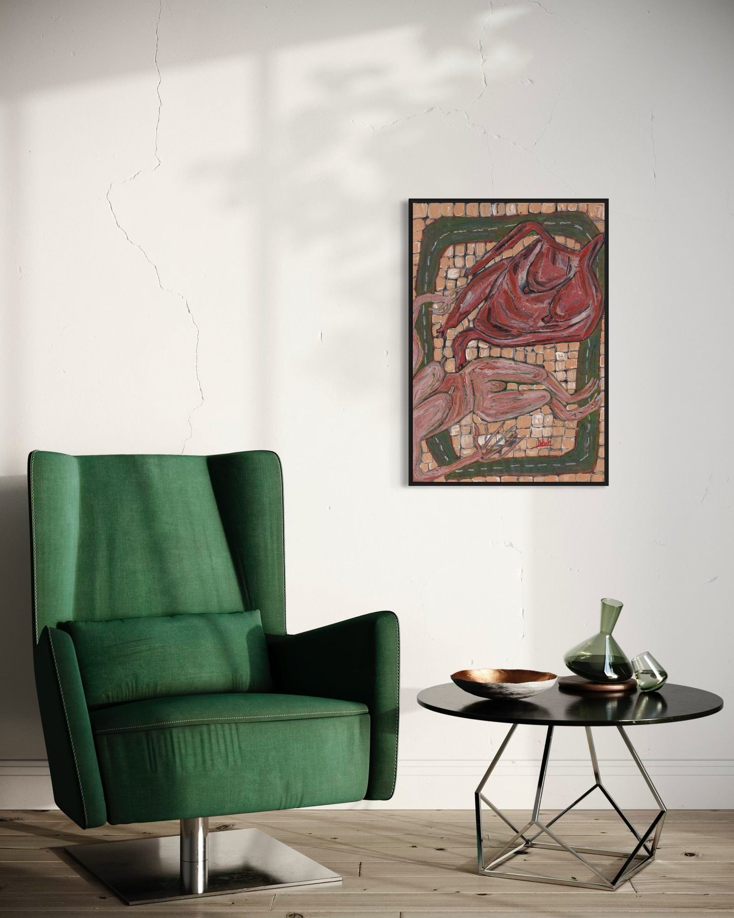 Green armchair in a room with a table and decorative wall art.