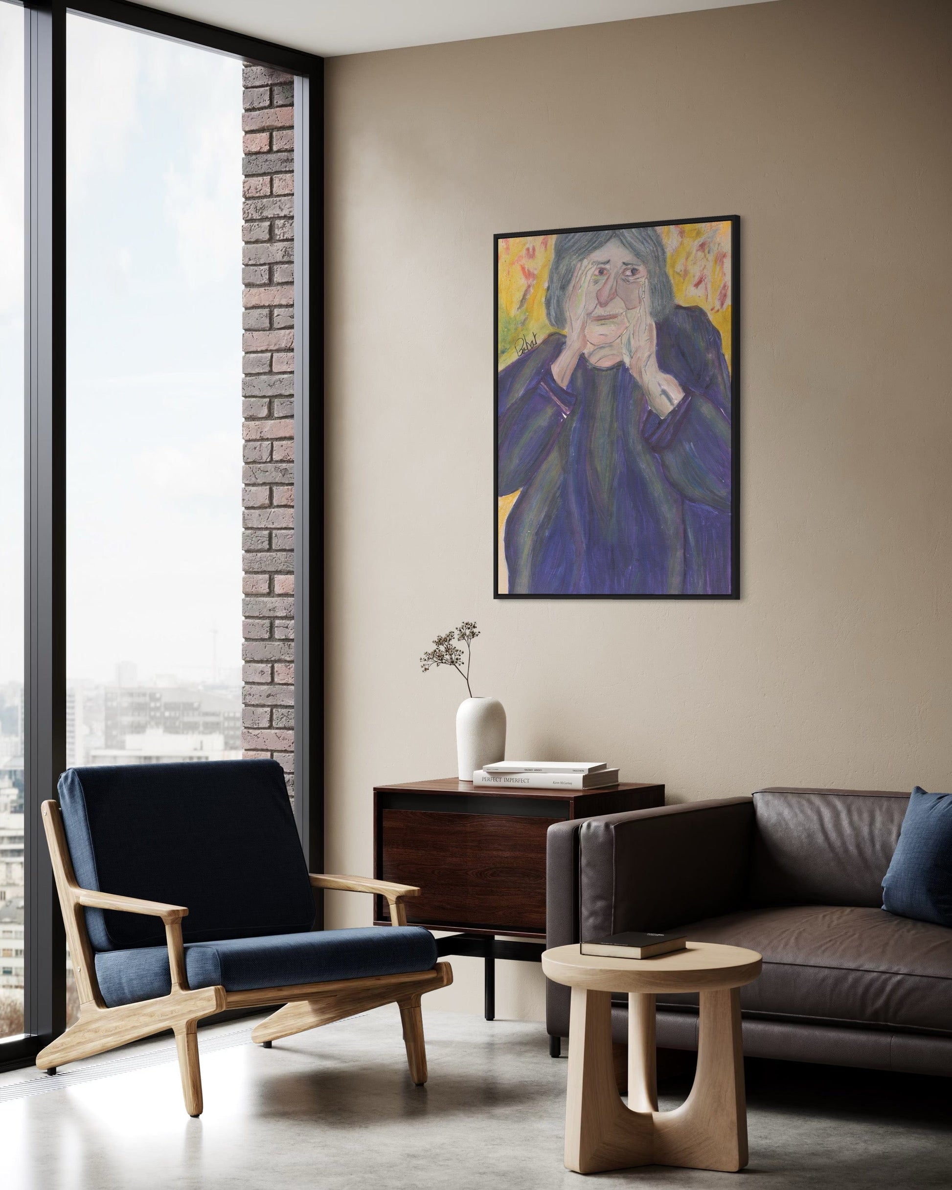 Modern living room with a painting of an elderly woman on the wall.