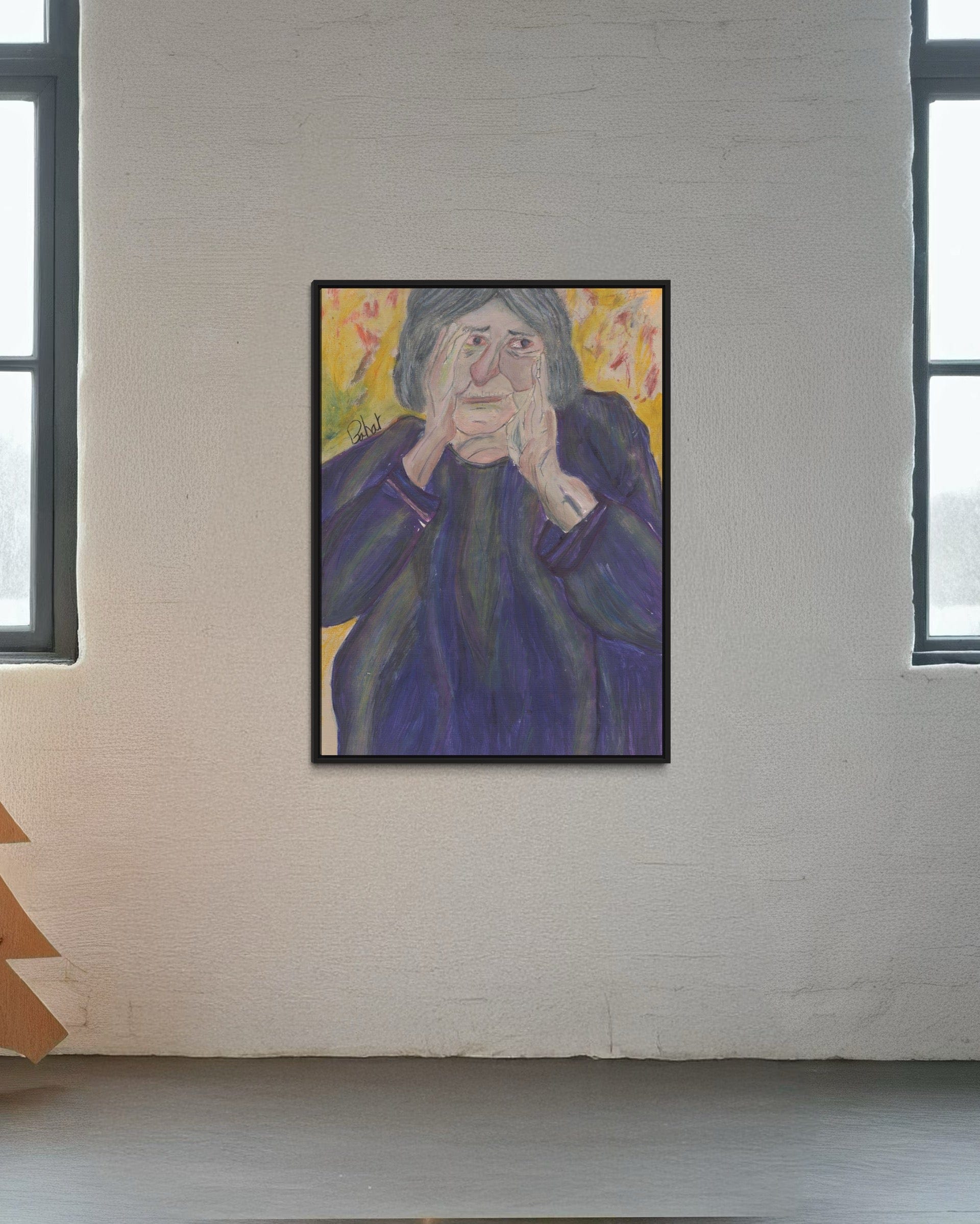 Framed painting of an elderly woman on a white brick wall.