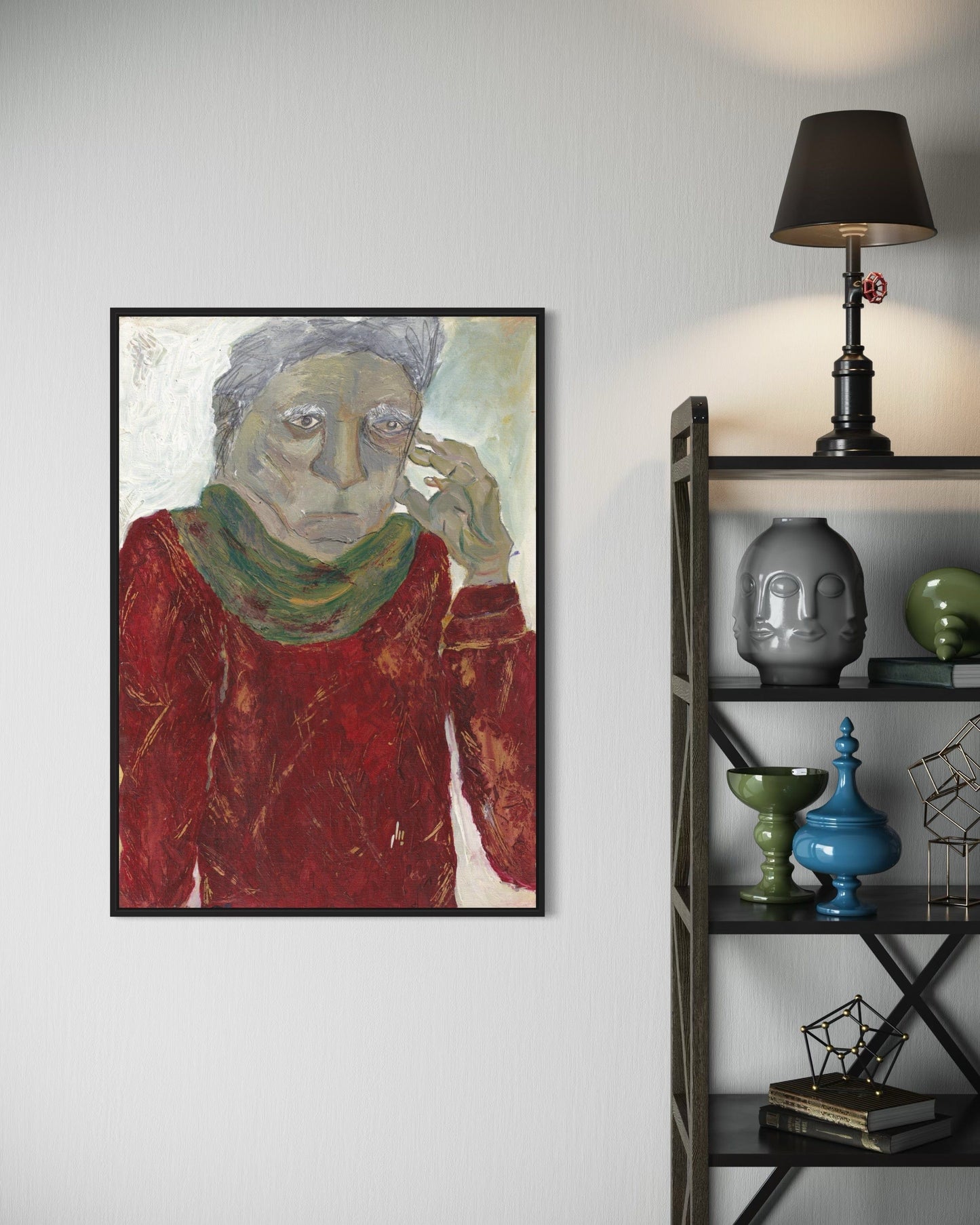 Framed artwork of a person with a red sweater and green scarf on a wall next to a shelf with decorative items.