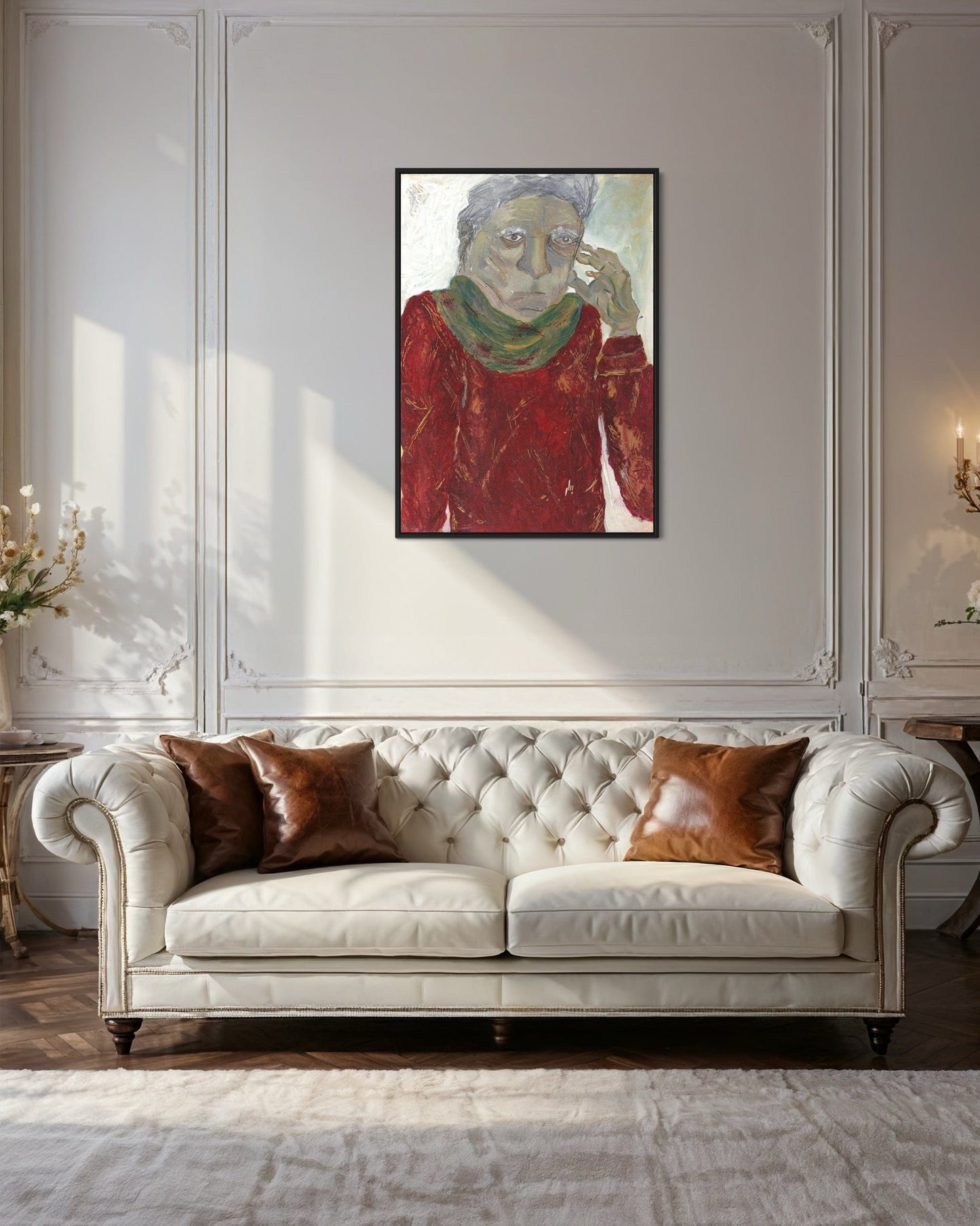 White tufted sofa with brown cushions in a room with a framed painting on the wall.