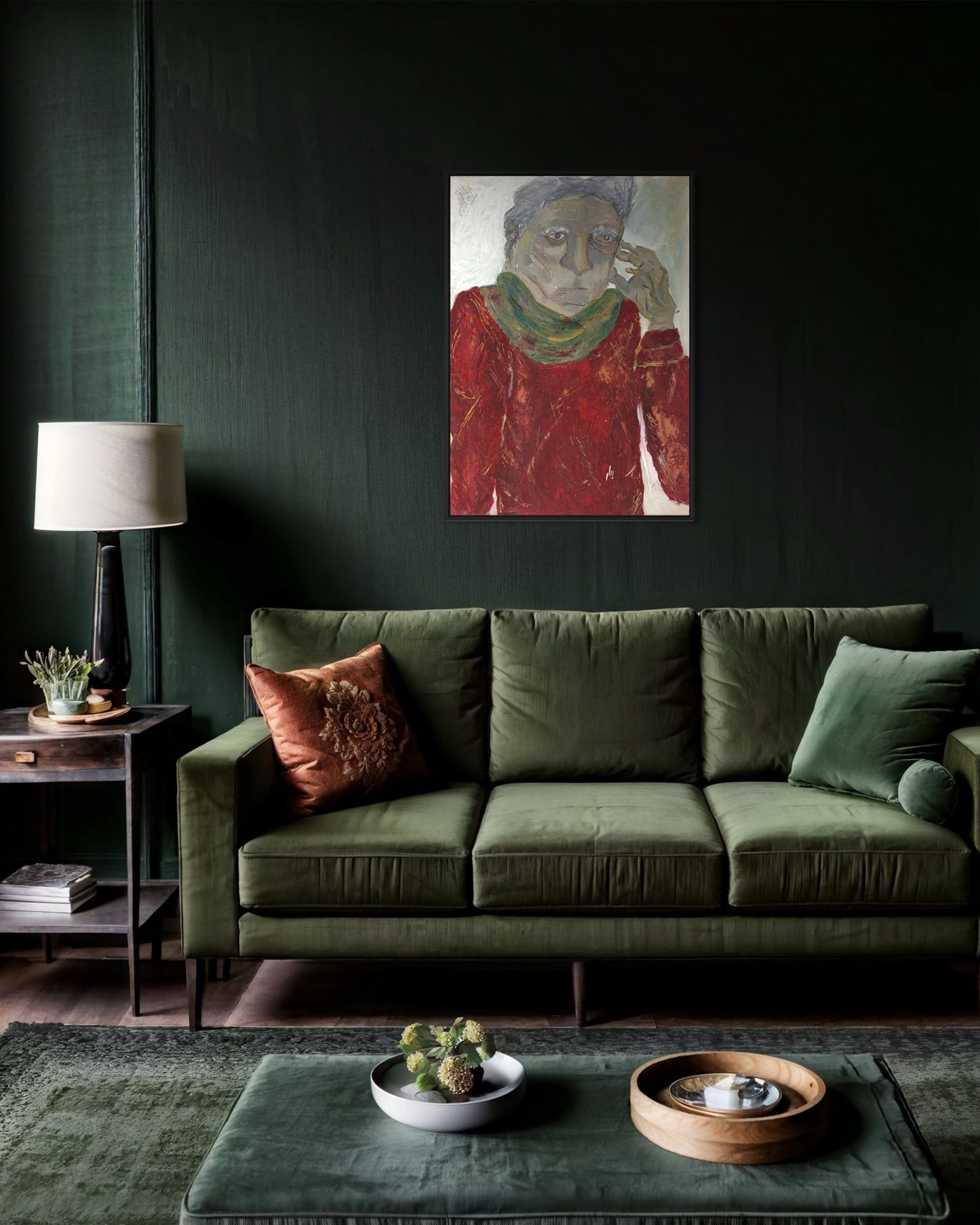 Green sofa in a living room with a painting on the wall