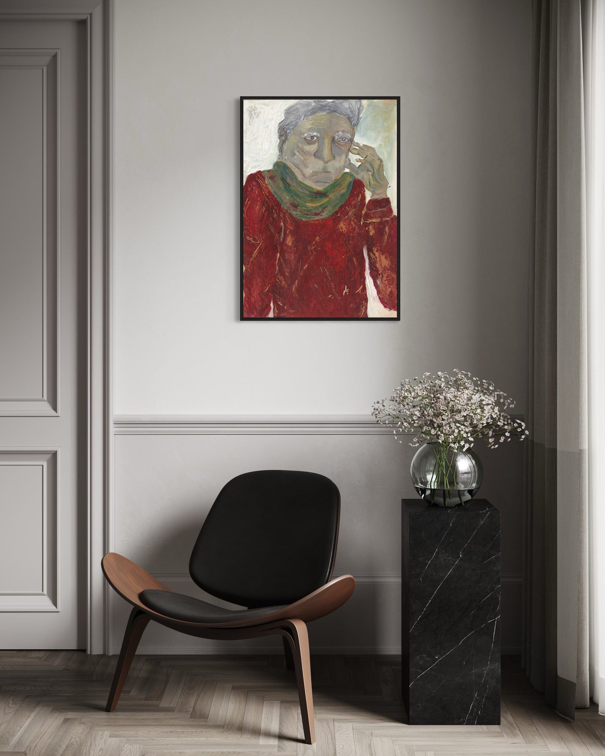 Modern interior with a black chair, marble side table, and framed artwork on a gray wall.