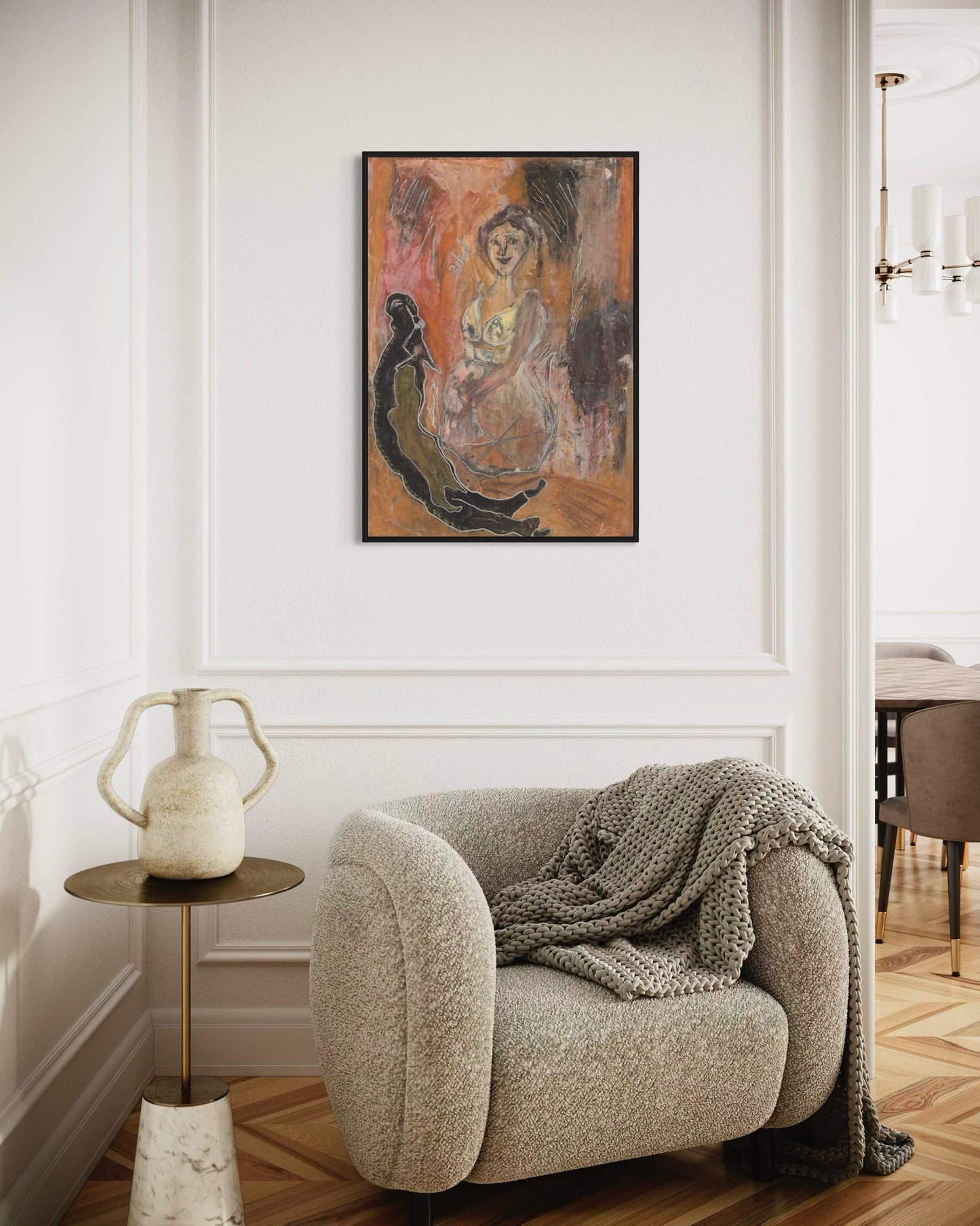 Cozy living room with a plush armchair, side table, and abstract painting on the wall.
