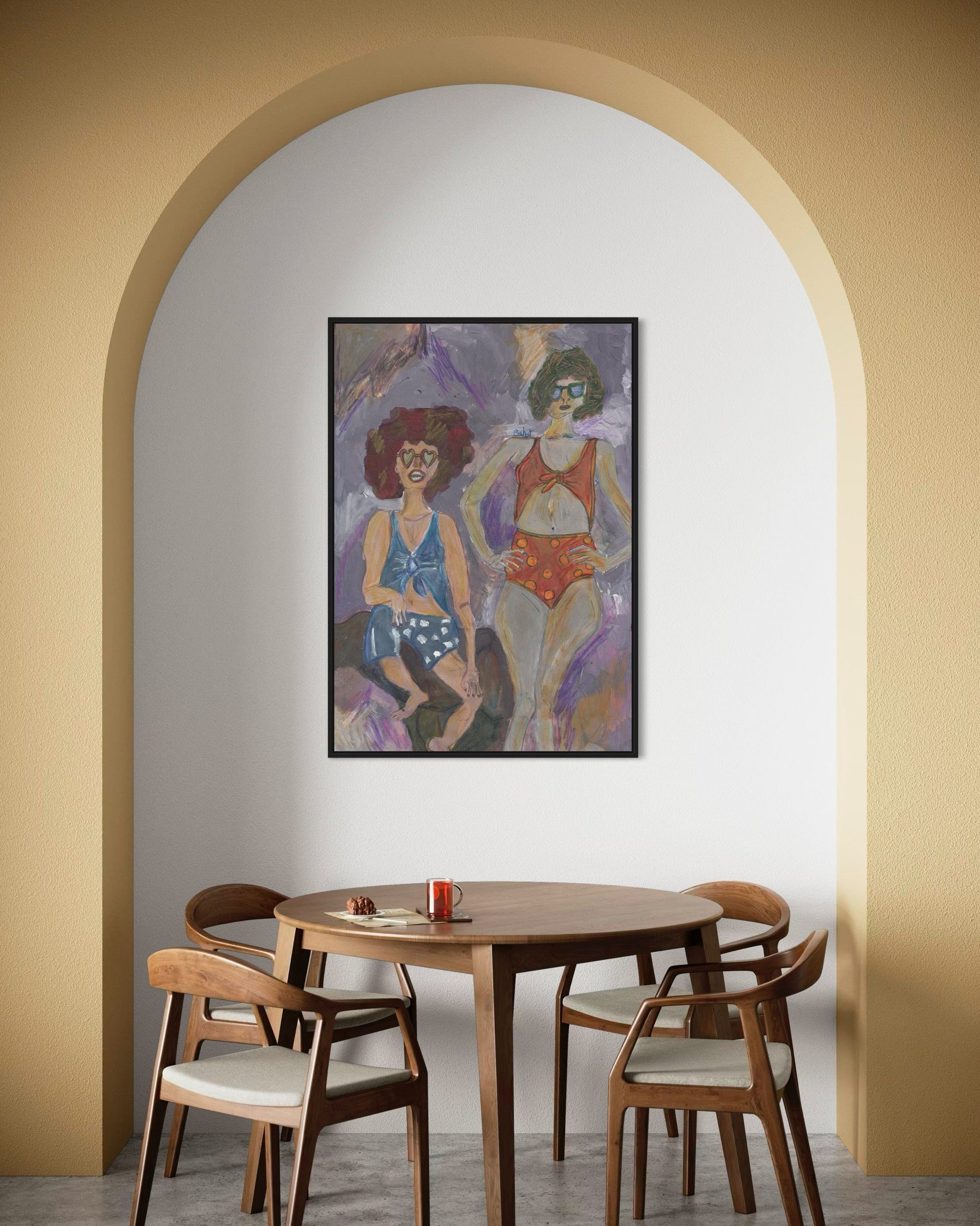 Dining room with wooden table and chairs, framed artwork on the wall.