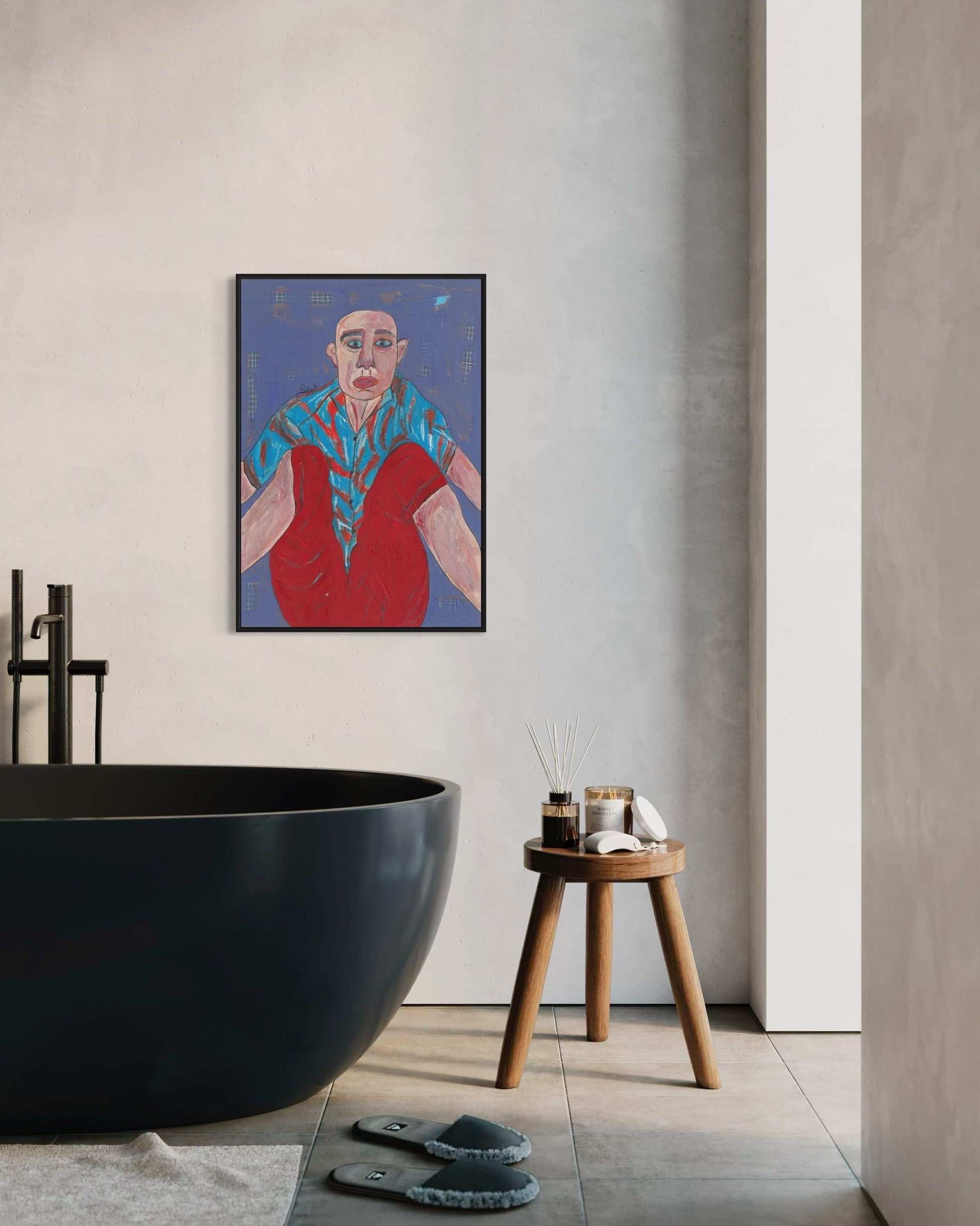 Modern bathroom interior with a black freestanding bathtub, wooden stool, and abstract painting on the wall.