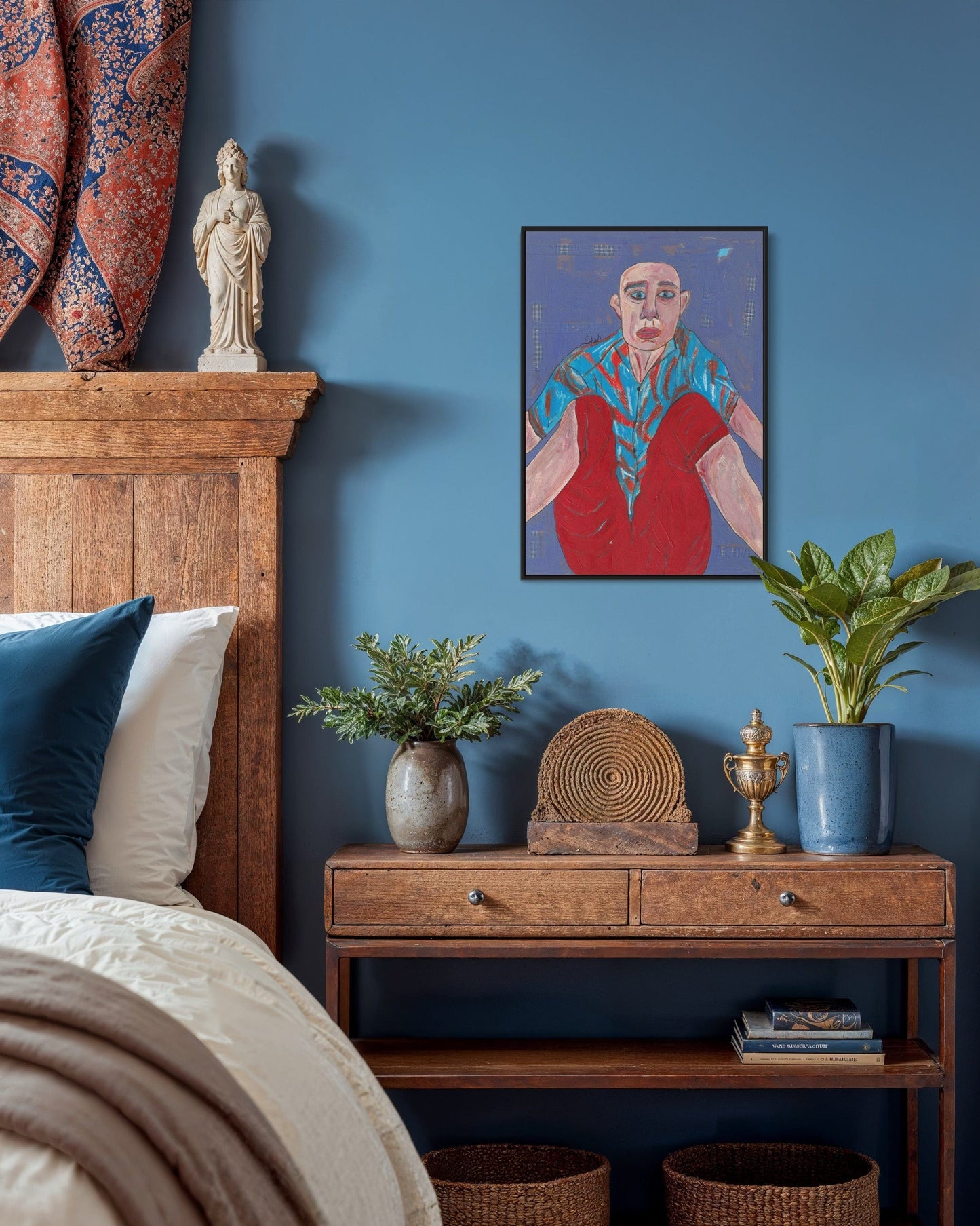 Room interior with wooden headboard, nightstand, and wall art against a blue wall.
