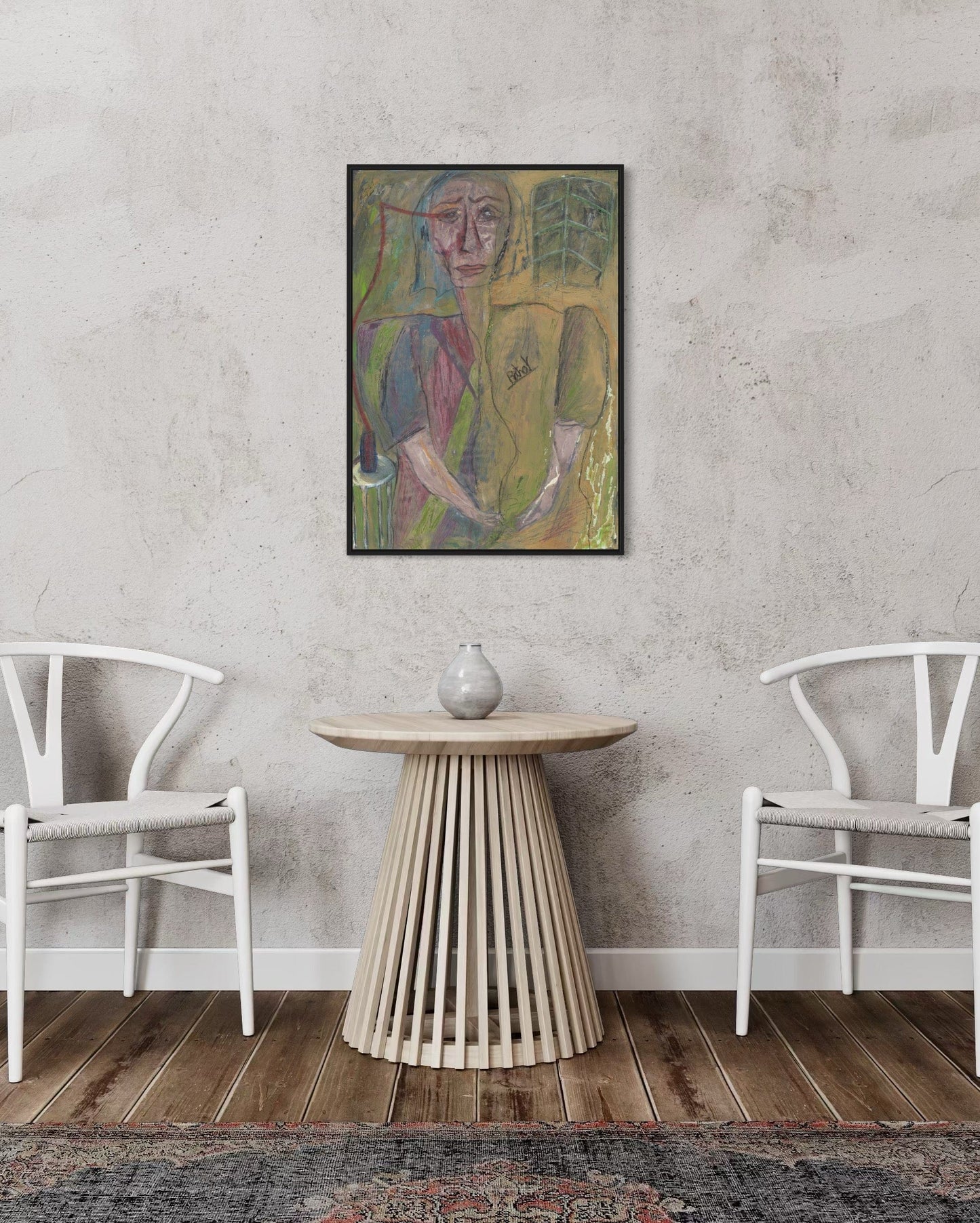 Framed abstract painting on a wall above a wooden side table with two white chairs.