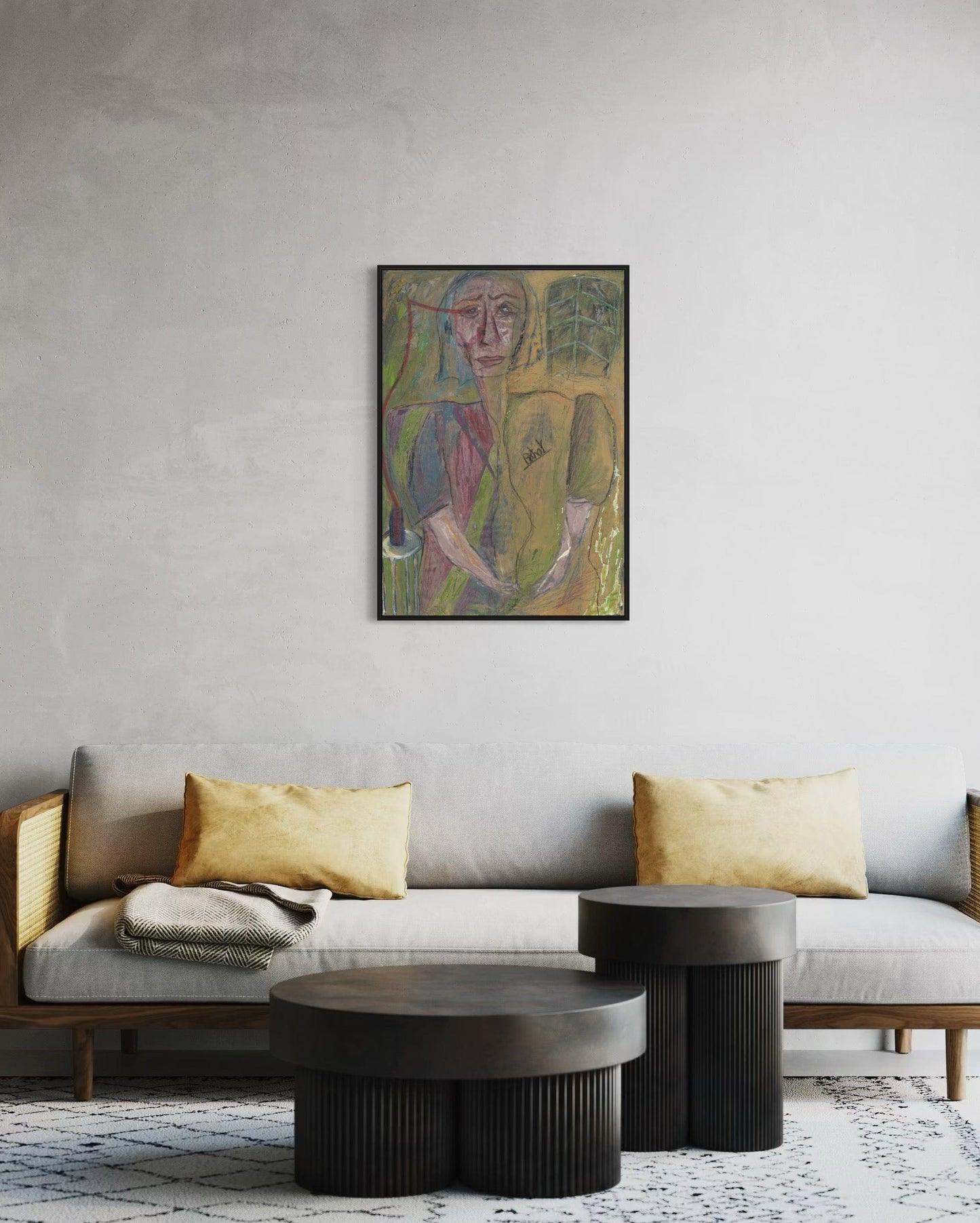 Living room with a gray sofa, gold pillows, and a framed abstract painting on the wall.
