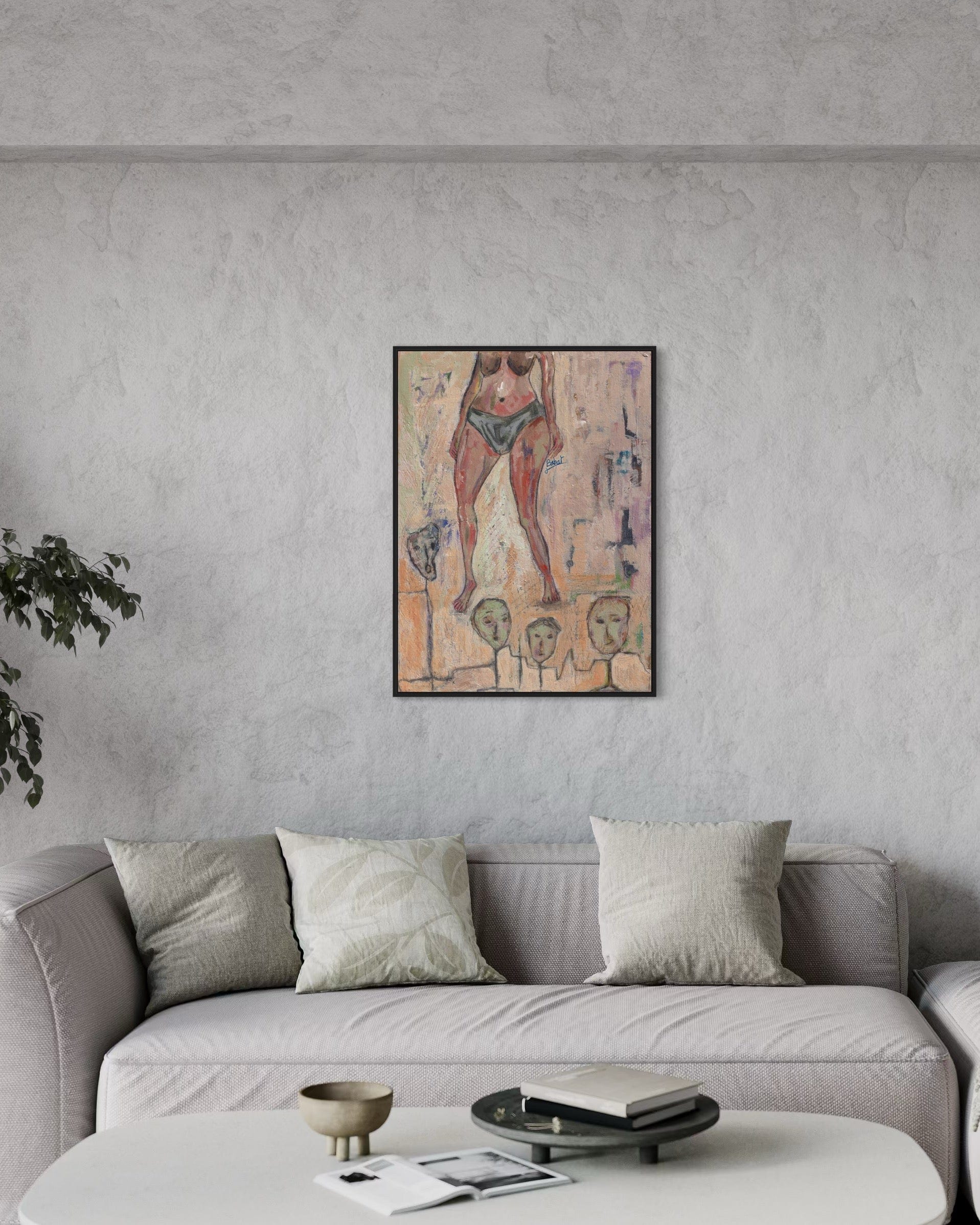 Framed artwork on a gray wall above a sofa in a living room.