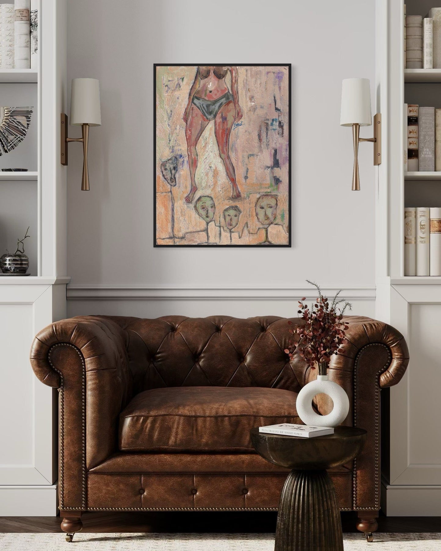 Brown leather sofa in a room with a painting on the wall and decorative items.