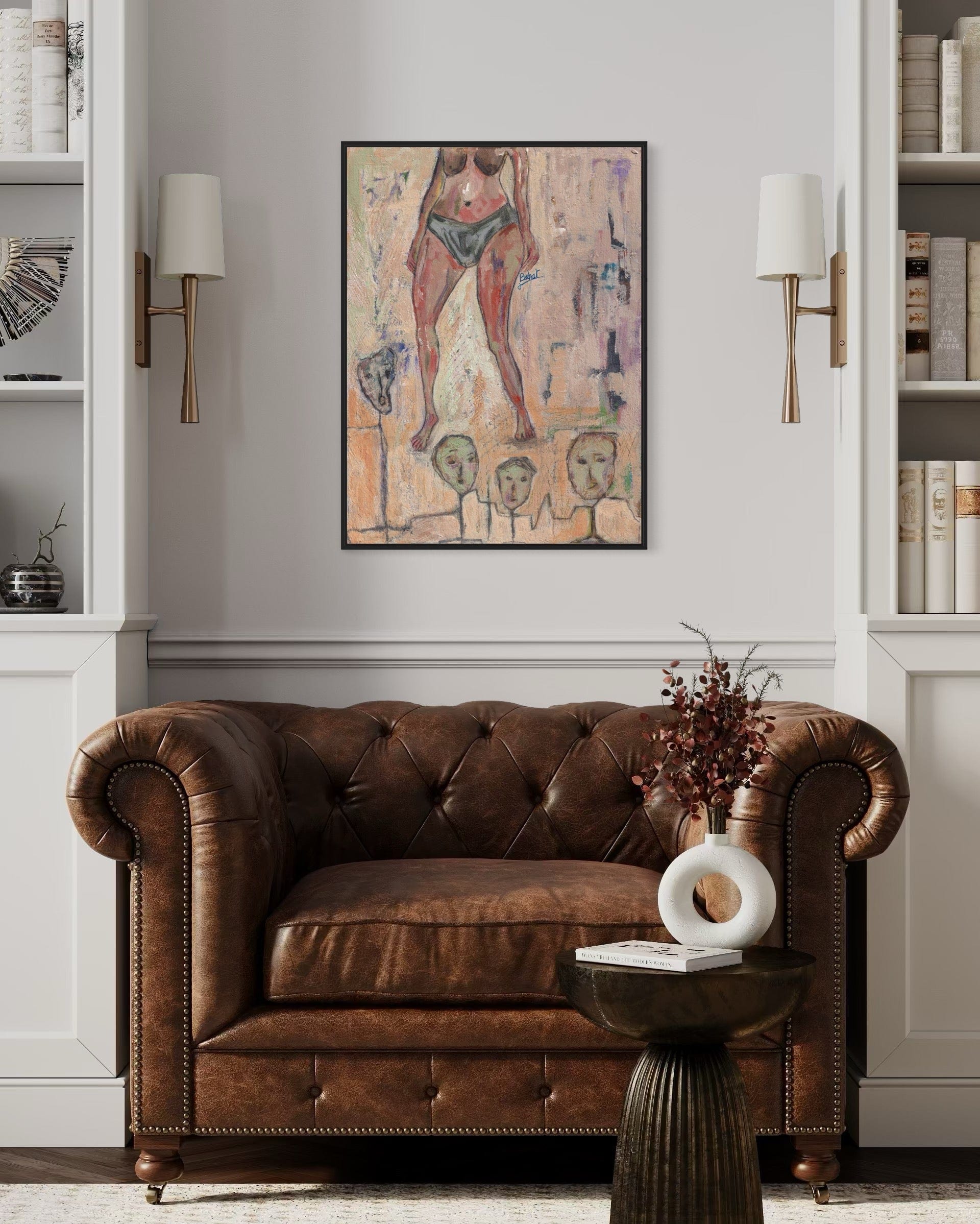 Brown leather sofa in a room with a painting on the wall and decorative items.