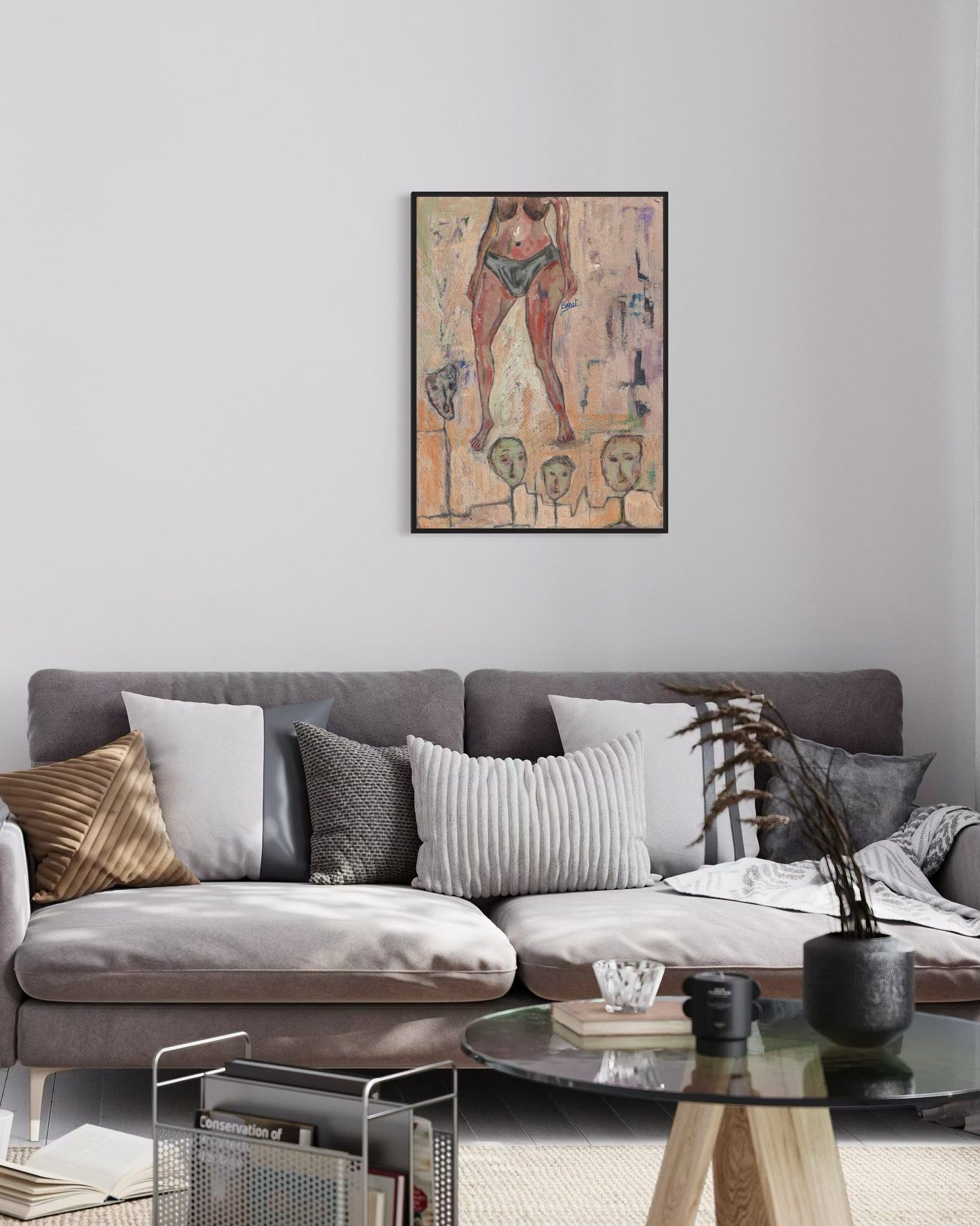 Living room with a gray sofa, decorative pillows, and a colorful abstract painting on the wall.