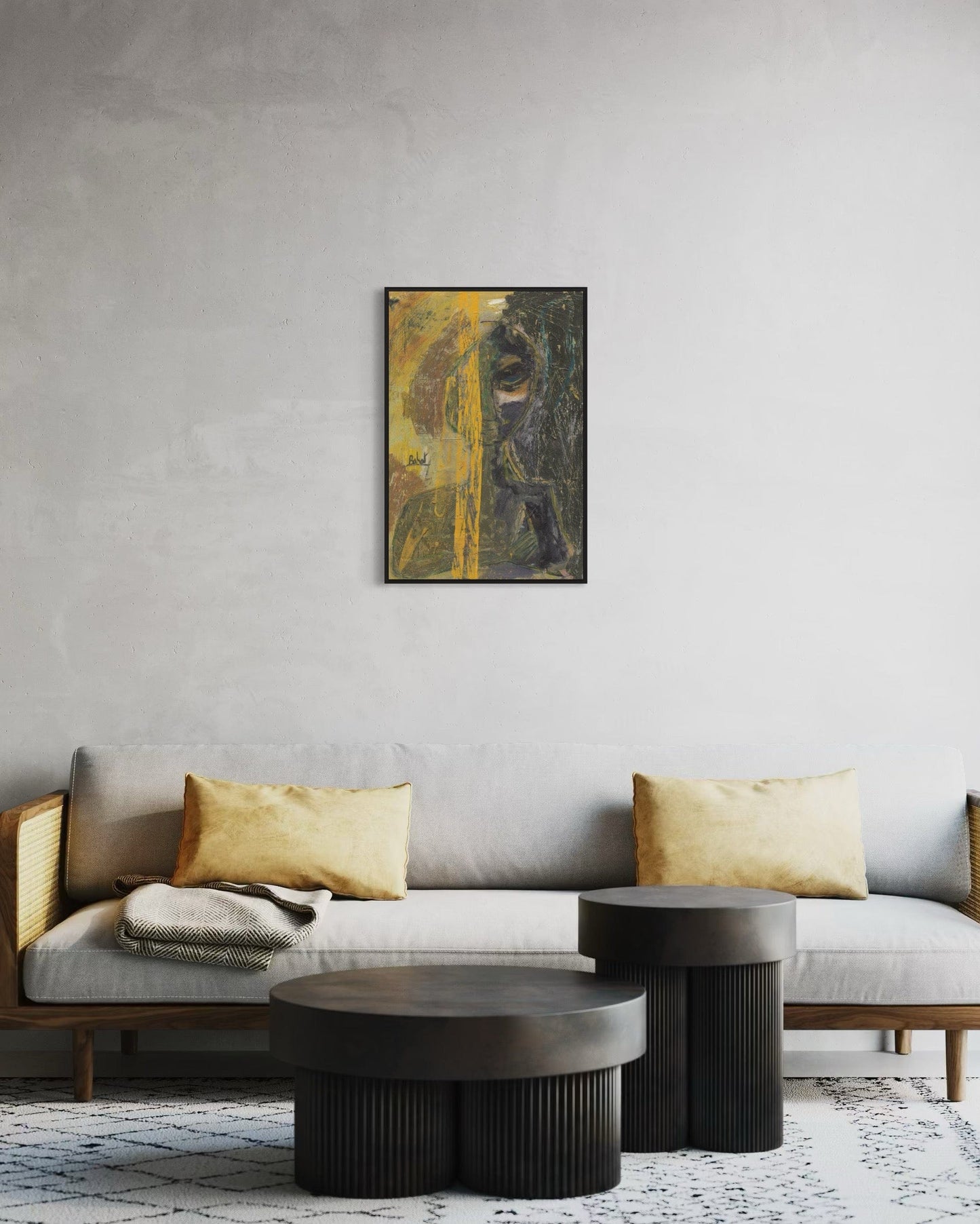 Gray sofa with gold cushions and dark coffee tables against a gray wall with a framed abstract painting.