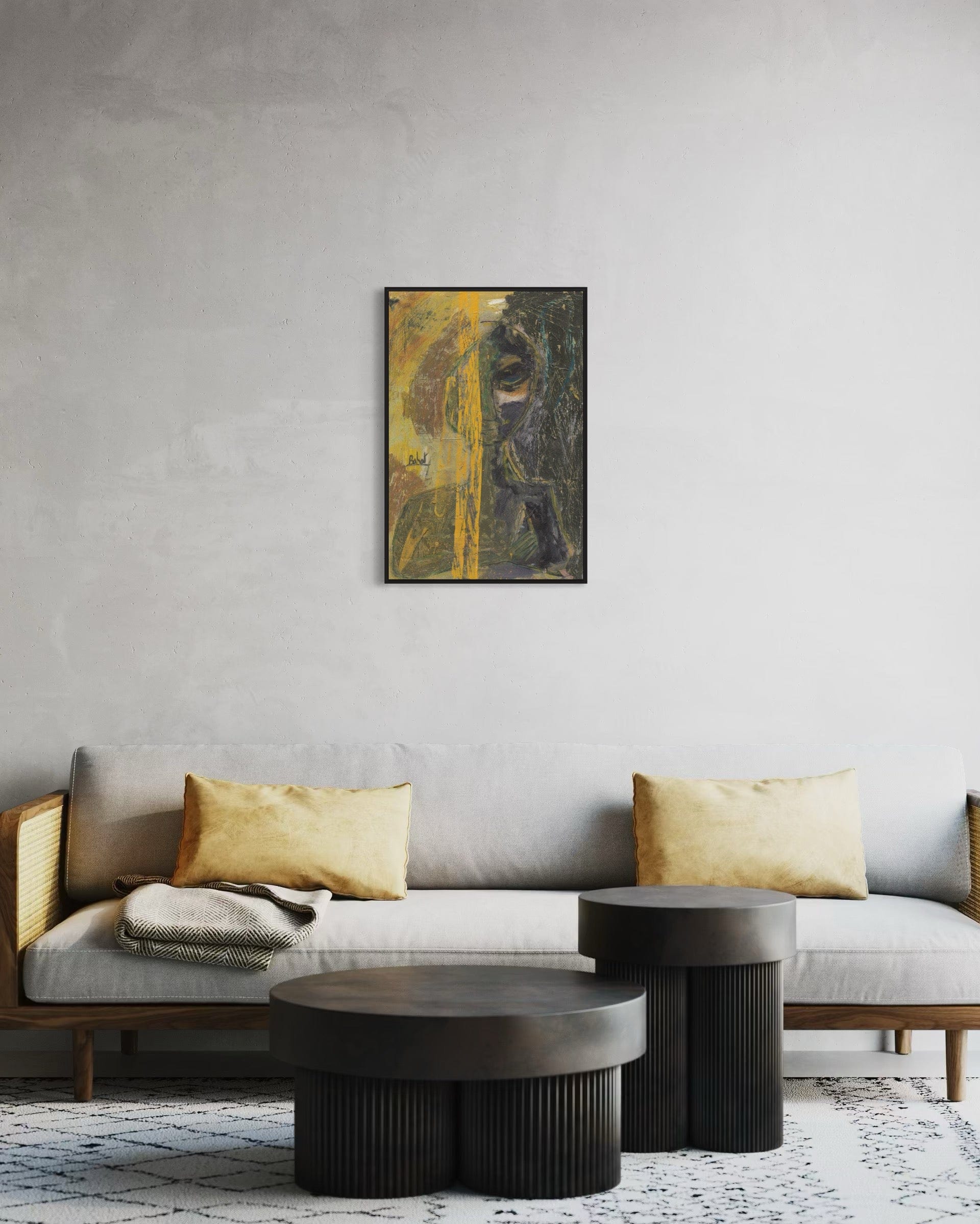 Gray sofa with gold cushions and dark coffee tables against a gray wall with a framed abstract painting.