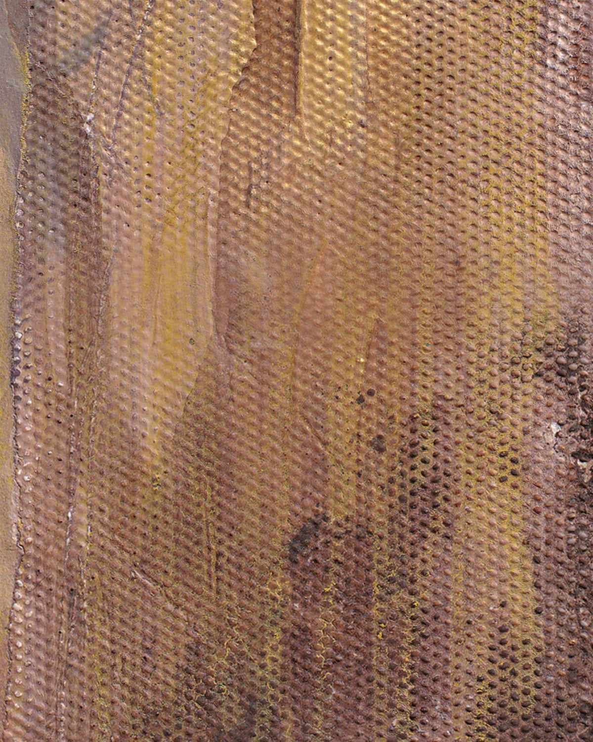 Close-up of a textured fabric with brown and yellow hues