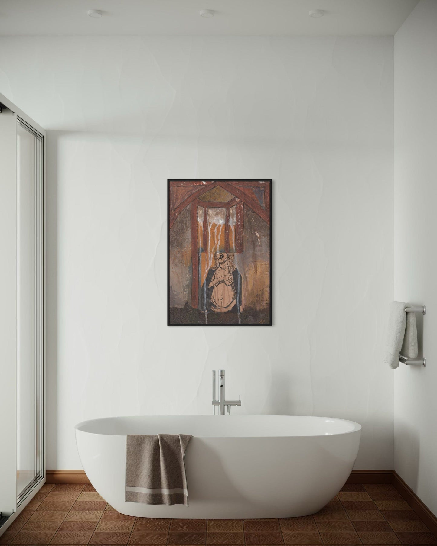 Bathroom with a freestanding bathtub and a framed artwork on the wall.