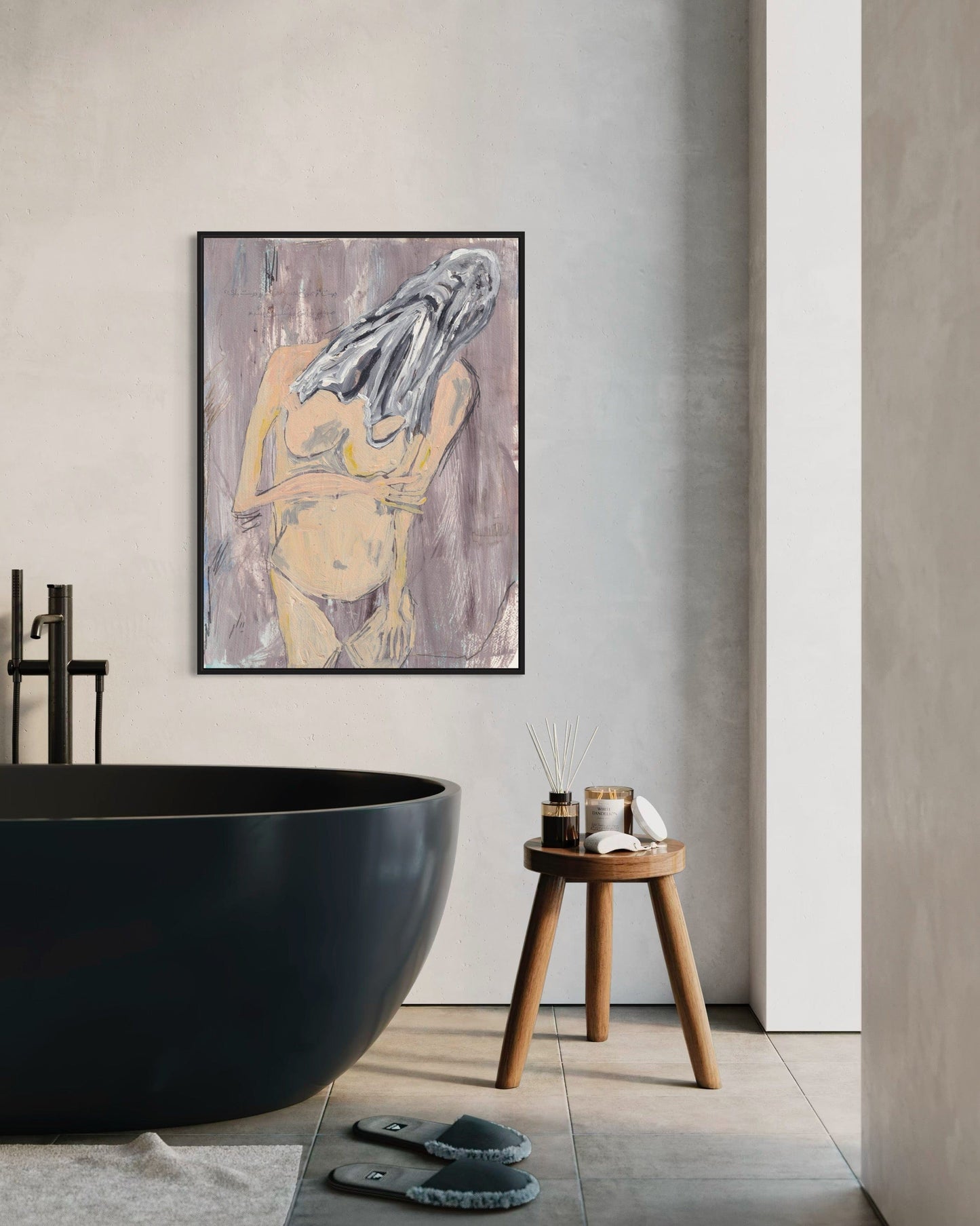 Modern bathroom interior with a black freestanding bathtub, wooden stool, and abstract art on the wall.