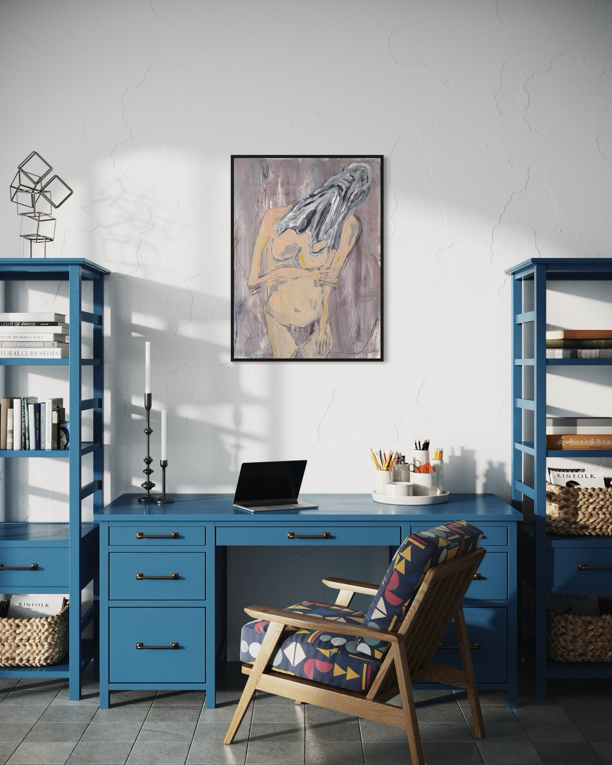 Home office with blue desk, bookshelves, and a chair with a colorful pattern.